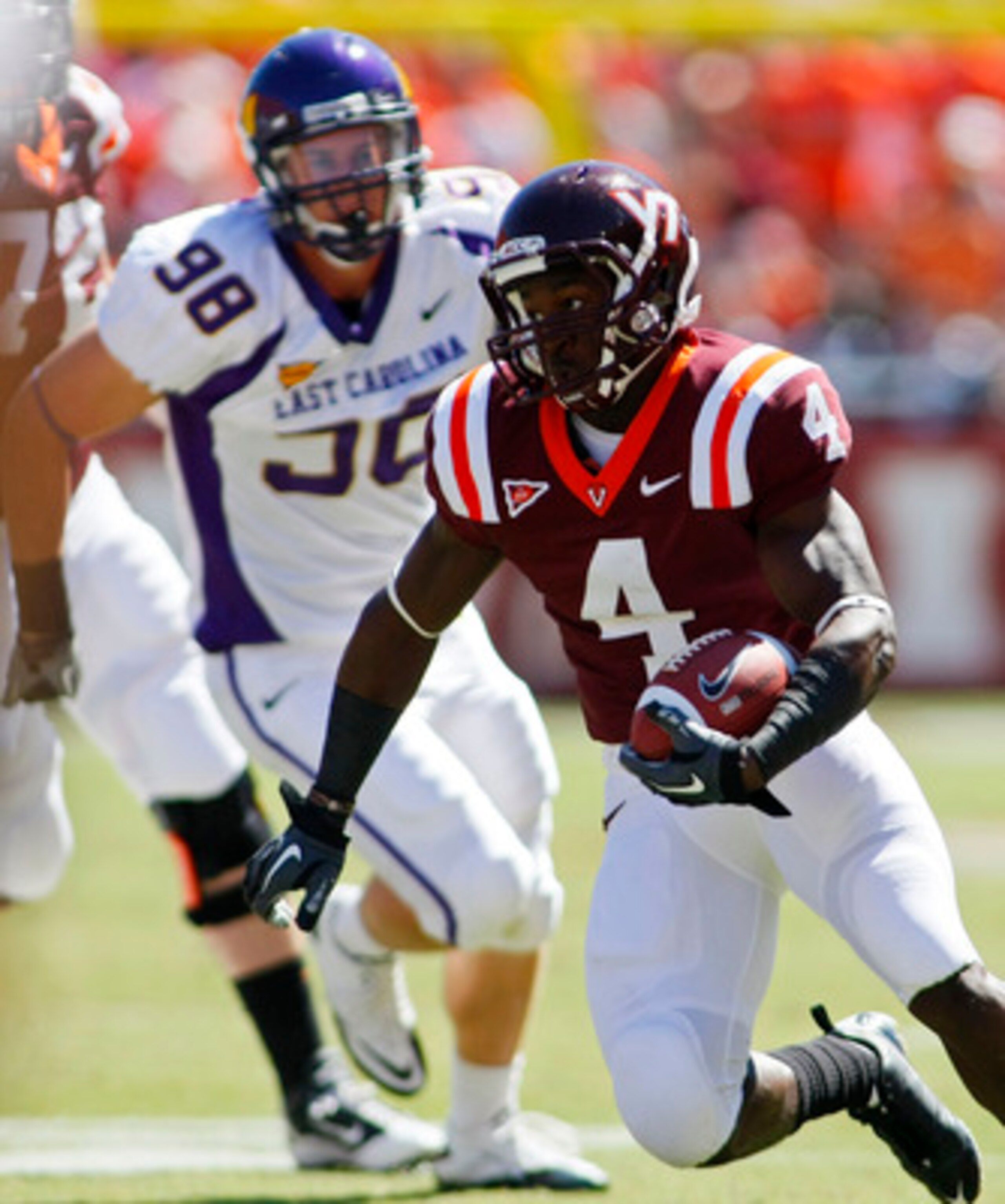BLACKSBURG, VA - SEPTEMBER 18: Running back David Wilson #4 of the Virginia Tech Hokies runs with the ball as defensive tackle Matt Milner #98 of the East Carolina Pirates chases at Lane Stadium on September 18, 2010 in Blacksburg, Virginia.  (Photo by Ge