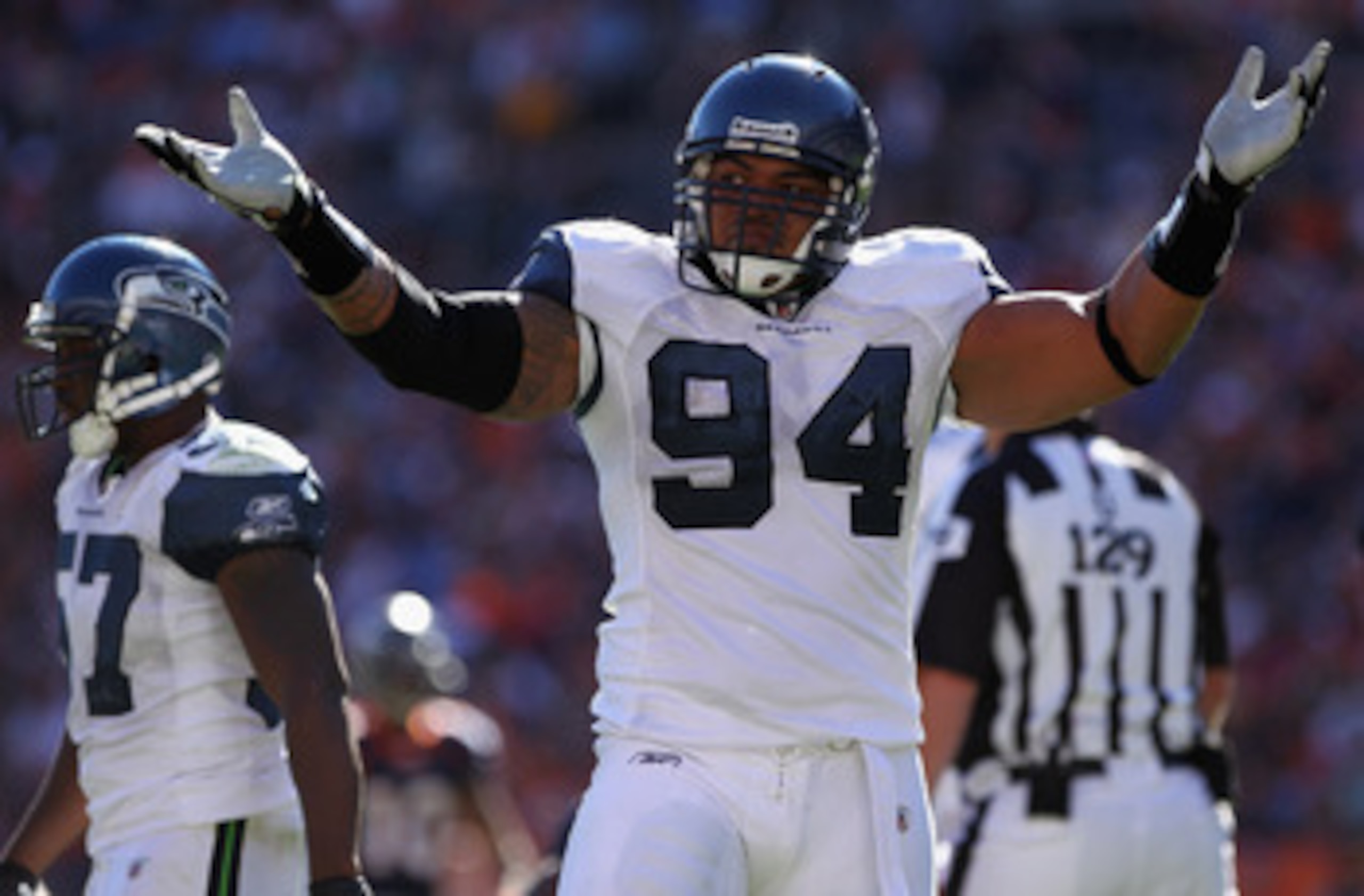 DENVER - SEPTEMBER 19:  Defensive lineman Junior Siavii #94 of the Seattle Seahawks celebrates after stopping running back Knowshon Moreno #27 of the Denver Broncos for a loss at INVESCO Field at Mile High on September 19, 2010 in Denver, Colorado. The Br