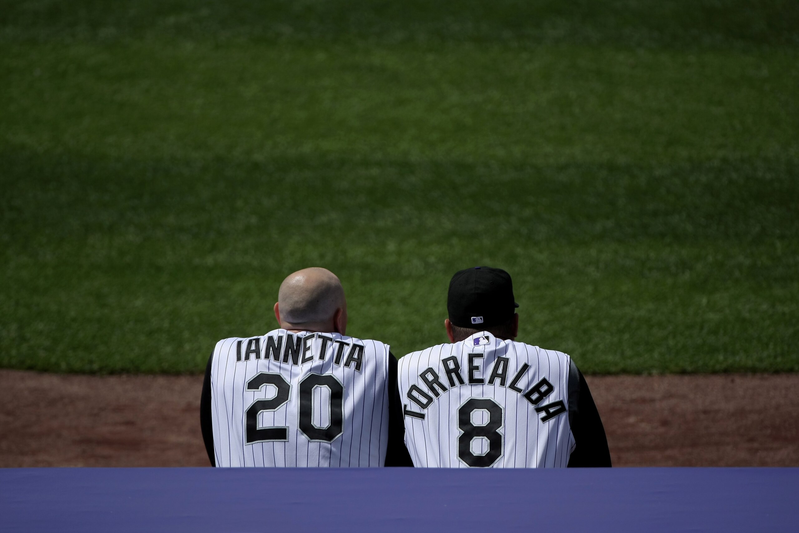 DENVER - MAY 18:  Catchers Chris Ianetta #20 and Yorvit Torreabla #8 of the Colorado Rockies watch the action from the duggout against the Minnesota Twins during Interleague MLB action at Coors Field on May 18, 2008 in Denver, Colorado. The Rockies defeat