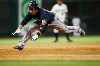 HOUSTON - APRIL 30:  Carlos Gomez #27 of the Milwaukee Brewers dives into third base against the Houston Astros at Minute Maid Park on April 30, 2011 in Houston, Texas. Gomez attempted to stretch a double into a triple was tagged out at third.  (Photo by