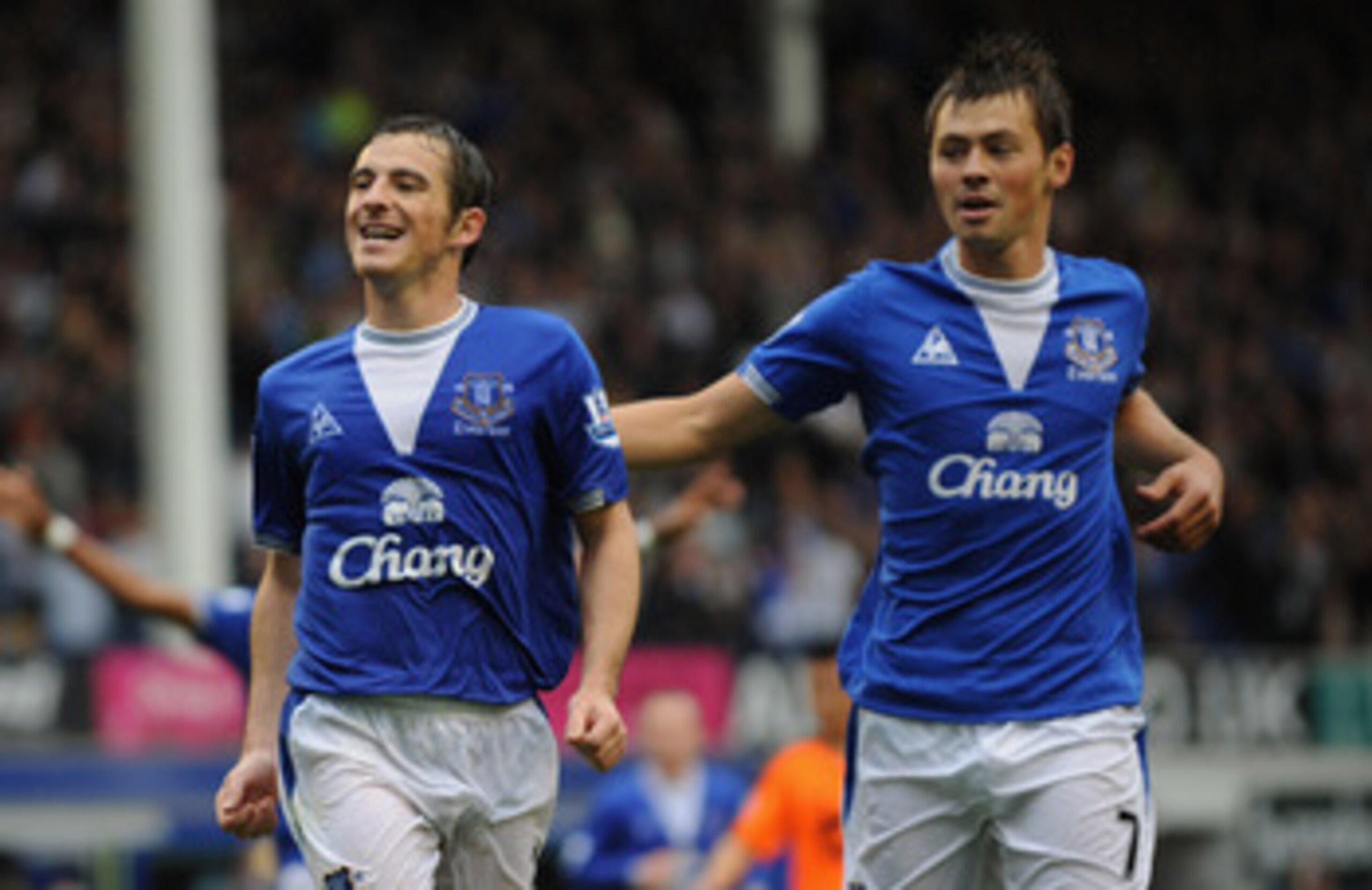 LIVERPOOL, ENGLAND - AUGUST 30:  Leighton Baines  (L) of Everton celebrates scoring his team's second goal from the penalty spot with team mate Diniyar Bilyaletdinov during the Barclays Premier League match between Everton and Wigan Athletic at Goodison P