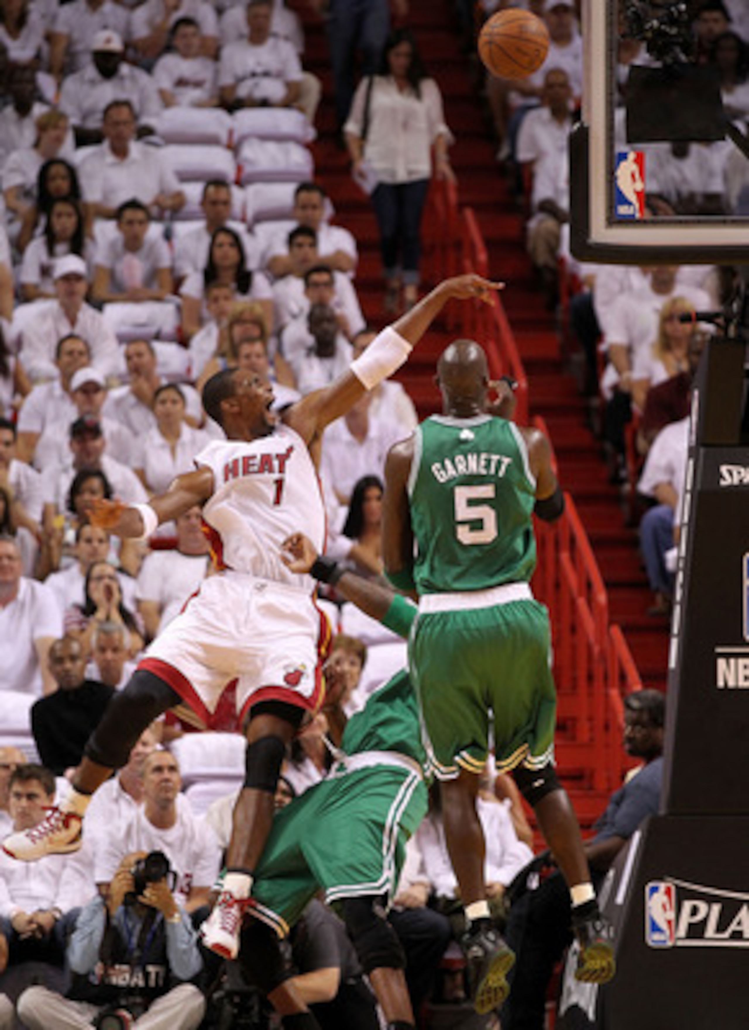MIAMI, FL - MAY 03:  Chris Bosh #1 of the Miami Heat takes a shot over Kevin Garnett #5 and Jermaine Oneal #7 of the Boston Celticsduring Game Two of the Eastern Conference Semifinals of the 2011 NBA Playoffs at American Airlines Arena on May 3, 2011 in M