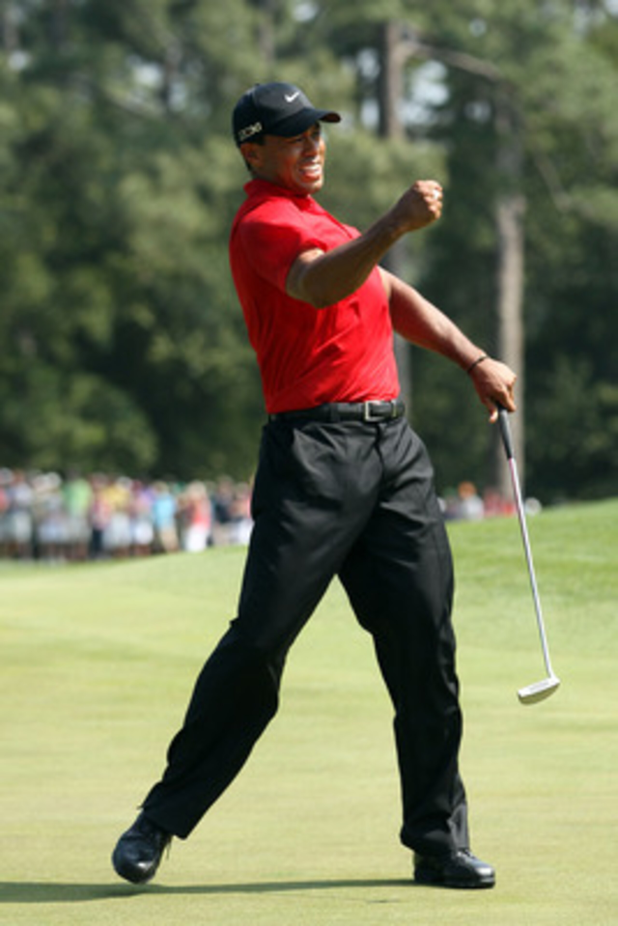 AUGUSTA, GA - APRIL 10:  Tiger Woods celebrates after holing a putt for eagle on the eighth green during the final round of the 2011 Masters Tournament on April 10, 2011 in Augusta, Georgia.  (Photo by Andrew Redington/Getty Images)