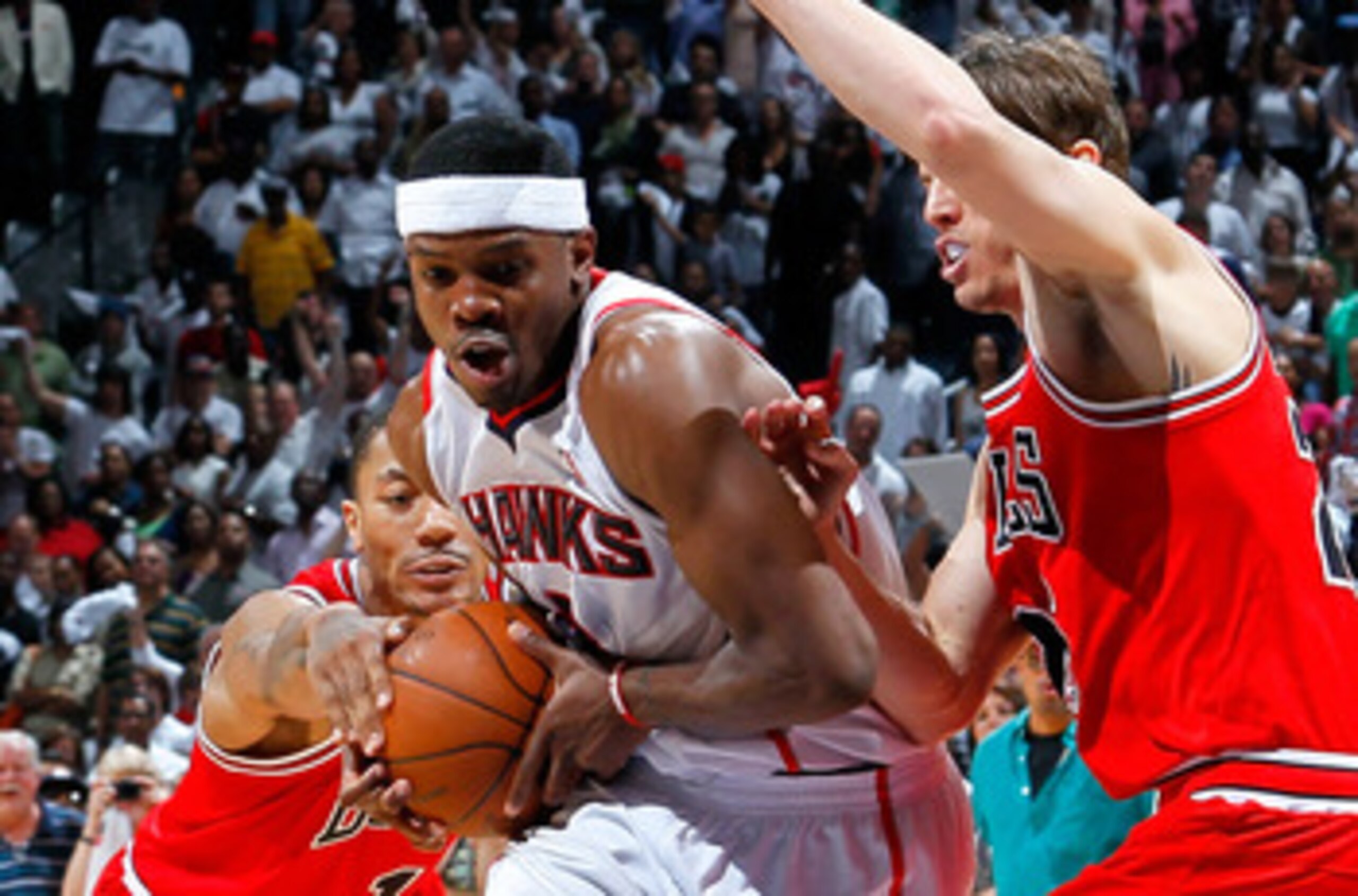 ATLANTA, GA - MAY 08:  Joe Johnson #2 of the Atlanta Hawks drives between Derrick Rose #1 and Kyle Korver #26 of the Chicago Bulls in Game Four of the Eastern Conference Semifinals in the 2011 NBA Playoffs at Phillips Arena on May 8, 2011 in Atlanta, Geor