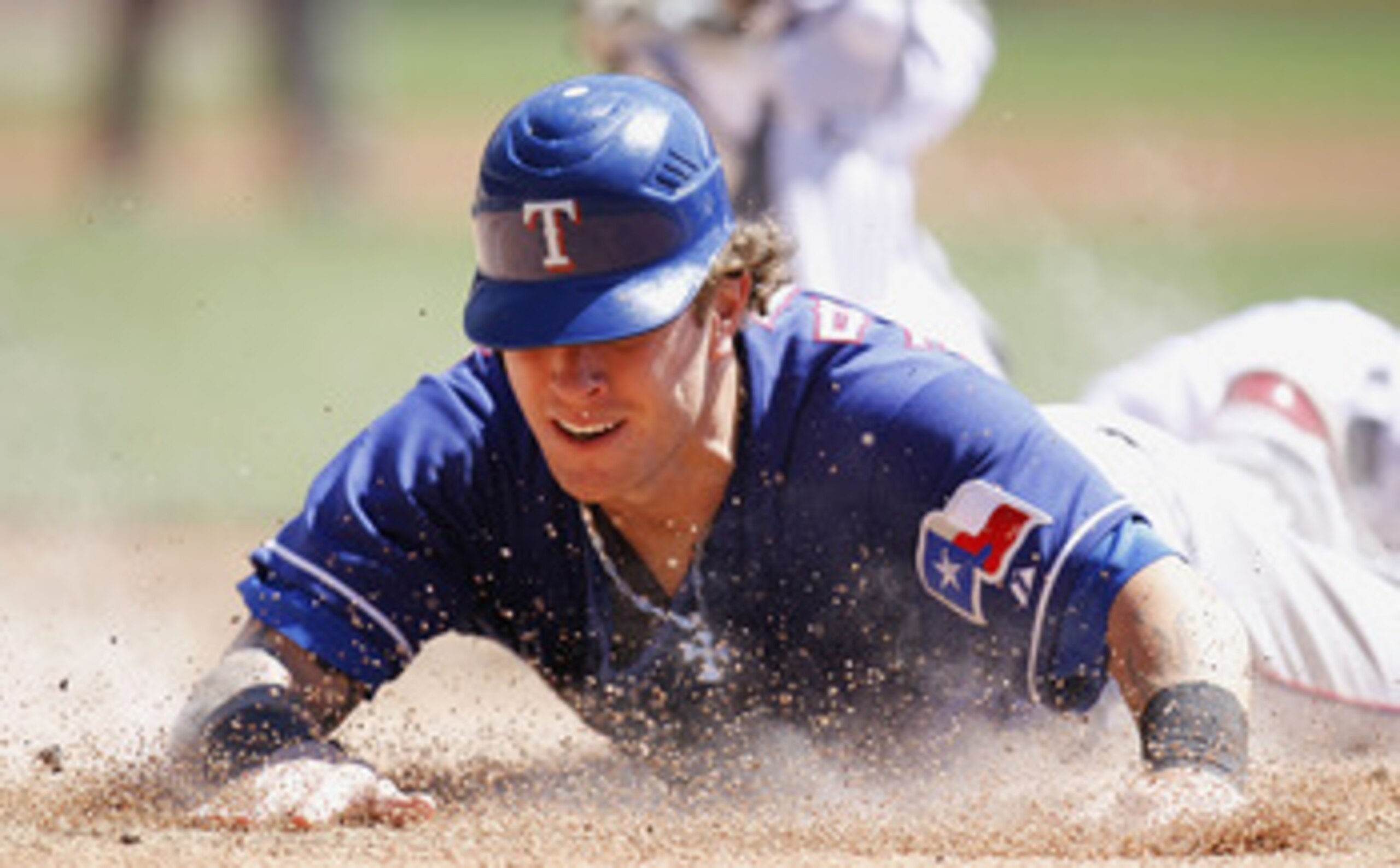 DETROIT, MI - APRIL 12:  Josh Hamilton #32 of the Texas Rangers slides into home plate during the third inning while playing the Detroit Tigers at Comerica Park on April 12, 2011 in Detroit, Michigan. Hamilton was out from a tag by Victor Martinez  (Photo