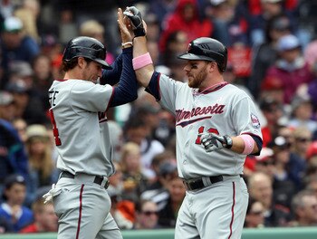 BOSTON, MA - MAY 08: Trevor Plouffe #24 and Jason Kubel #16 of the Minnesota Twins celebrate after they scored off a single by Danny Valencia in the first inning against the Boston Red Sox on May 8, 2011 at Fenway Park in Boston, Massachusetts. (Photo b BOSTON, MA - MAY 08: Trevor Plouffe #24 and Jason Kubel #16 of the Minnesota Twins celebrate after they scored off a single by Danny Valencia in the first inning against the Boston Red Sox on May 8, 2011 at Fenway Park in Boston, Massachusetts. (Photo b