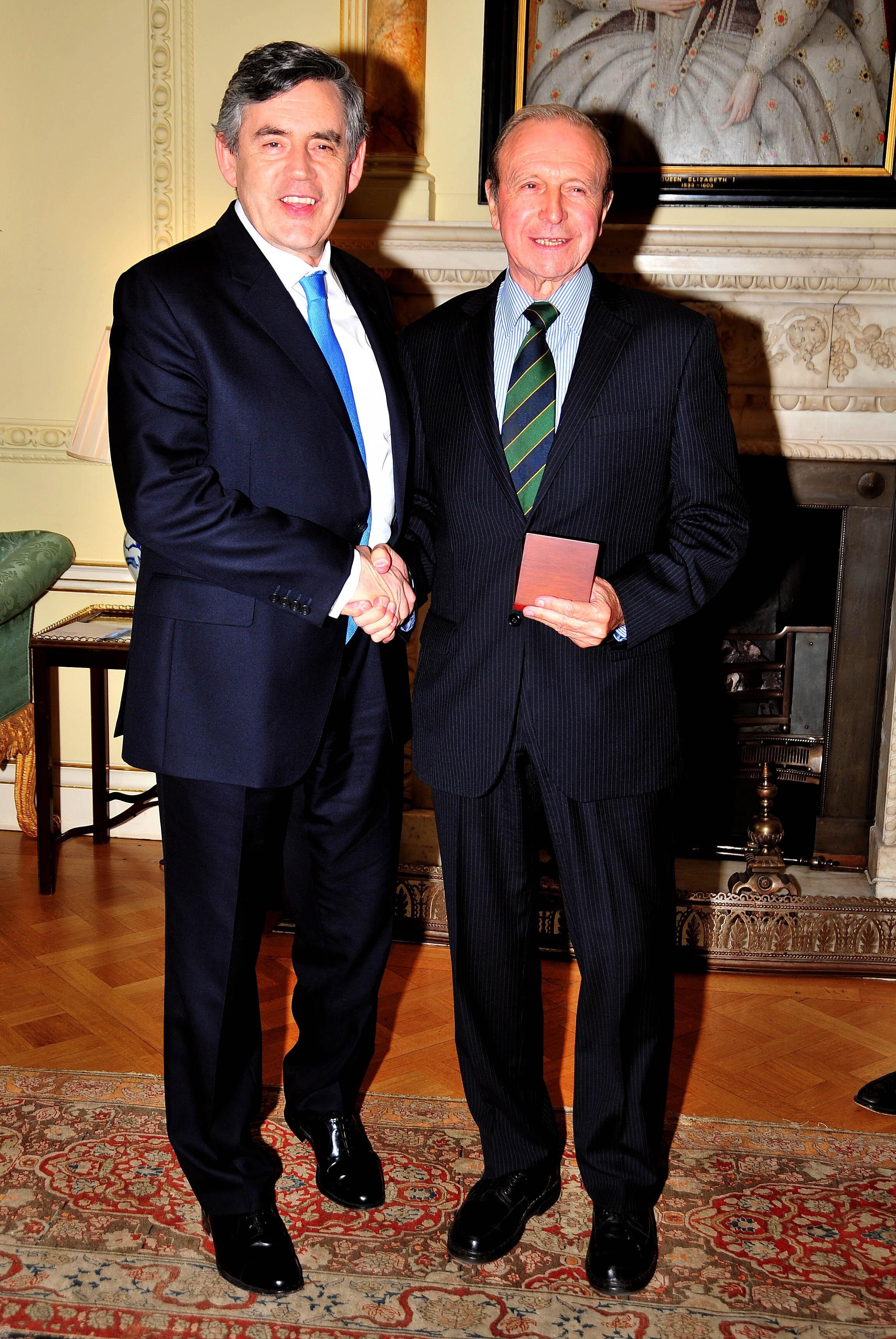 LONDON, UNITED KINGDOM - JUNE 10:  Jimmy Armfield (right) with his medal, presented by Prime Minister Gordon Brown (left) for representing his country in the 1966 World Cup at Downing Street on June 10, 2009 in London England. When England lifted the Worl
