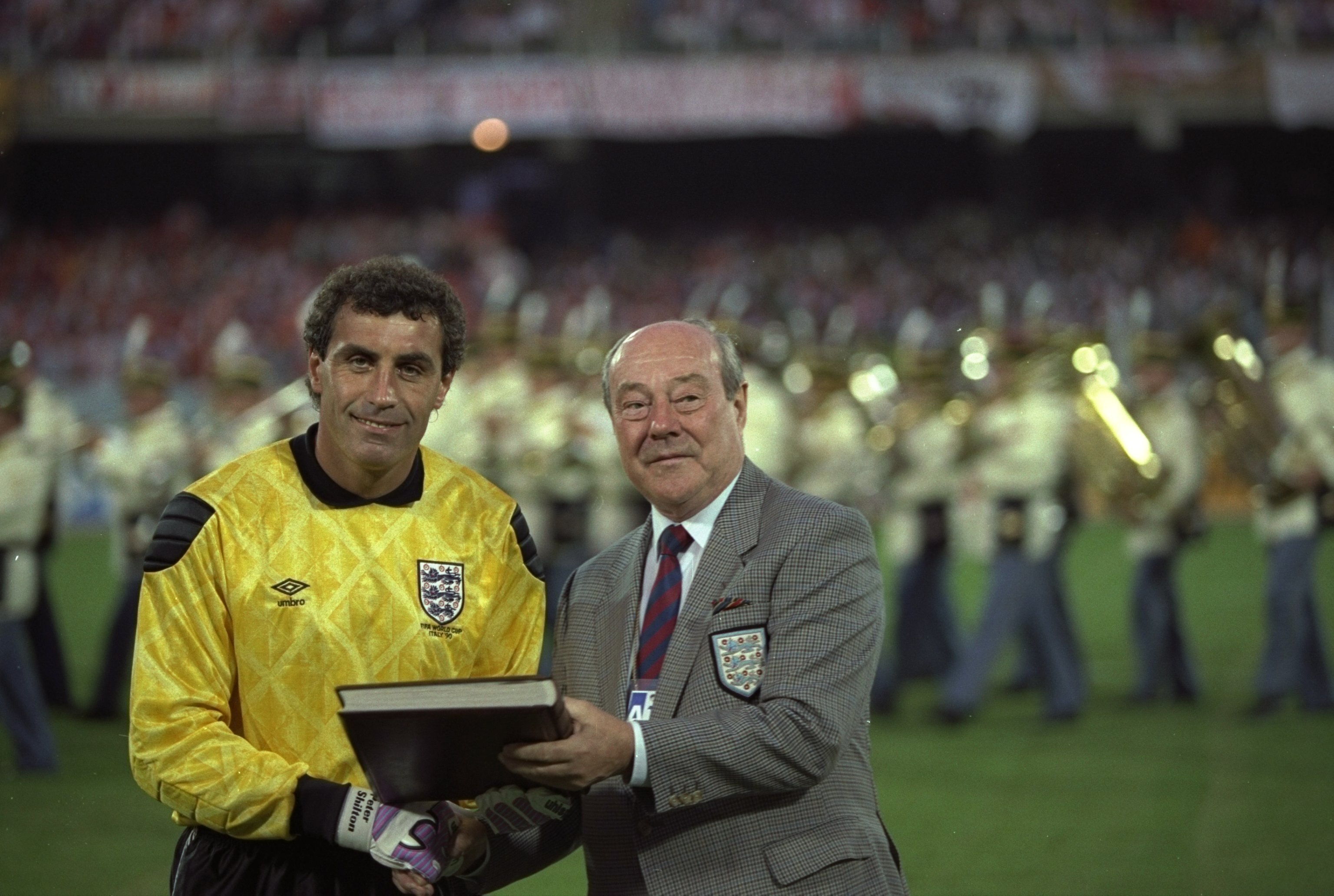 16 Jun 1990:  Peter Shilton (left) of England is awarded his 125th and World Record England Cap by Sir Bert Millichip (right) before the World Cup match against Holland in Cagliari, Italy. The match ended in a 0-0 draw. \ Mandatory Credit: David  Cannon/A