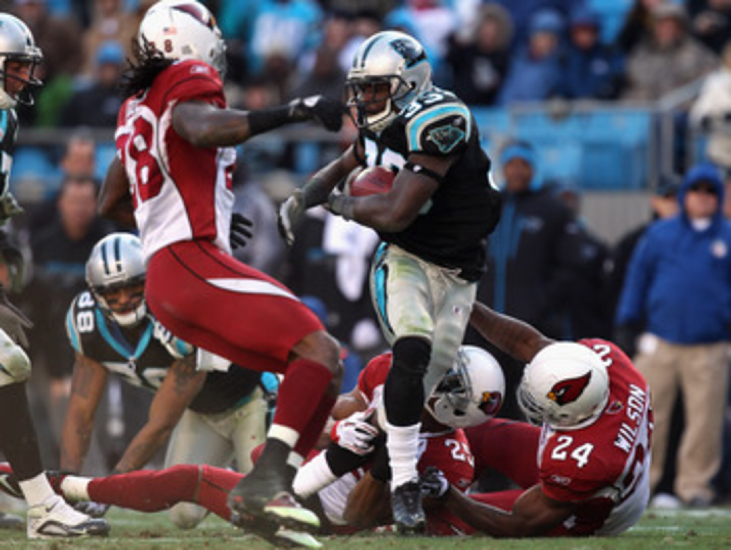 CHARLOTTE, NC - DECEMBER 19:  The defense of the Arizona Cardinals tries to stop Mike Goodson #33 of the Carolina Panthers during their game at Bank of America Stadium on December 19, 2010 in Charlotte, North Carolina.  (Photo by Streeter Lecka/Getty Imag