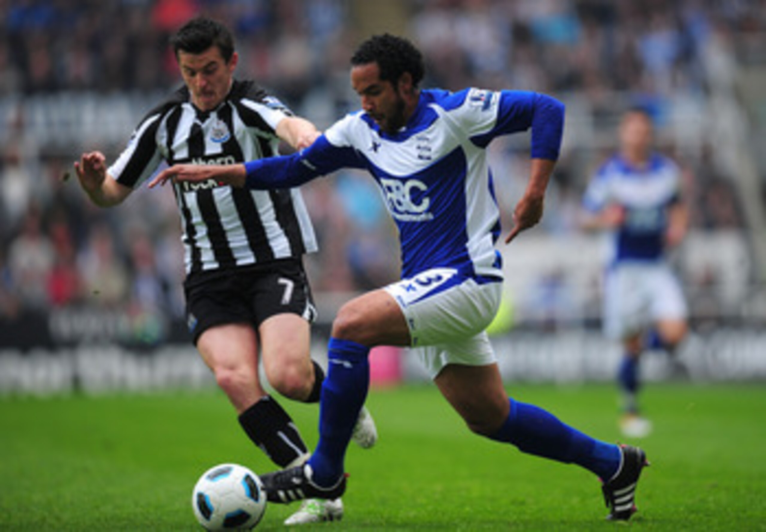 NEWCASTLE UPON TYNE, ENGLAND - MAY 07:  Newcastle player Joey Barton (l) challenges Jean Beausejour of Birmingham during the Barclays  Premier League game between Newcastle United and Birmingham City at St James' Park on May 7, 2011 in Newcastle upon Tyne