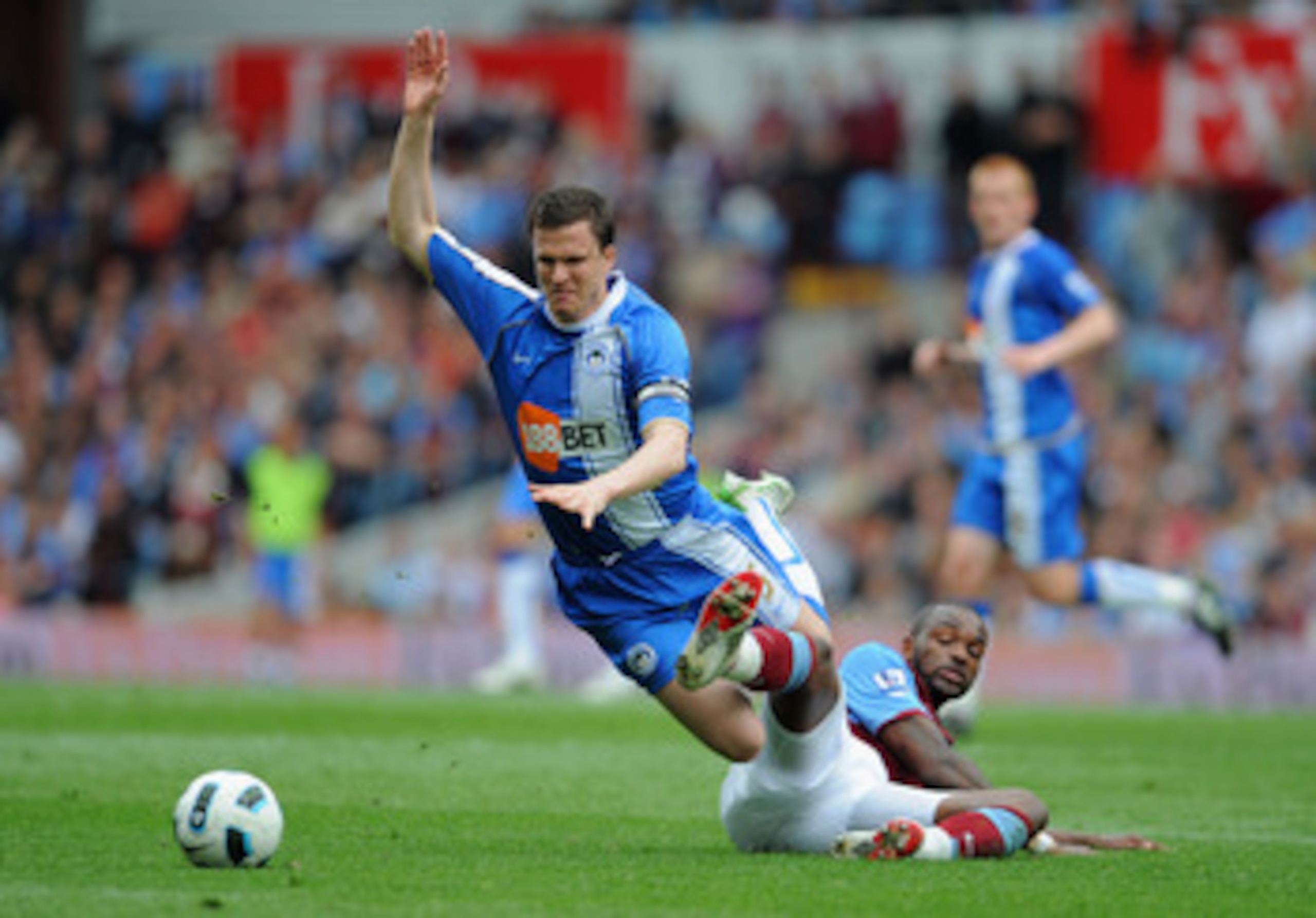 BIRMINGHAM, ENGLAND - MAY 07: Darren Bent of Villa tackles Gary Caldwell of Wigan during the Barclays Premier League match between Aston Villa and Wigan Athletic on May 7, 2011 in Birmingham, England.  (Photo by Michael Regan/Getty Images)
