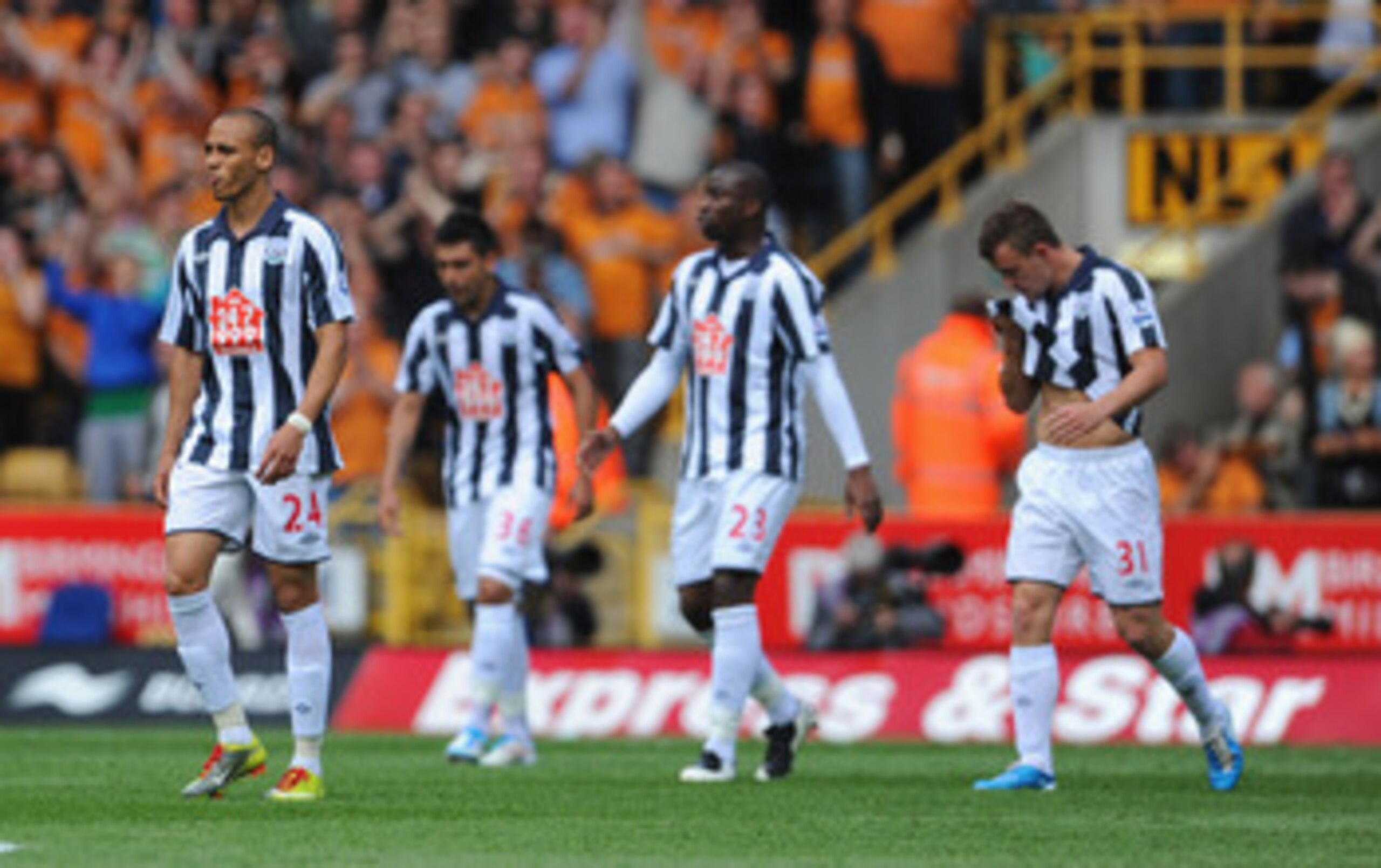 WOLVERHAMPTON, ENGLAND - MAY 08: Peter Odemwingie looks dejected with team mates after the 2nd Wolves goal during the Barclays Premier League match between Wolverhampton Wanderers and West Bromwich Albion at Molineux on May 8, 2011 in Wolverhampton, Engla