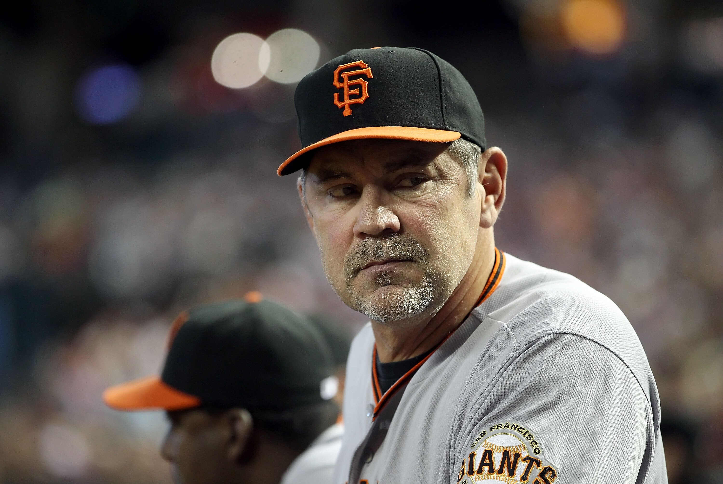 PHOENIX, AZ - APRIL 17:  Manager Bruce Bochy of the San Francisco Giants watches from the dugout during the Major League Baseball game against the Arizona Diamondbacks at Chase Field on April 17, 2011 in Phoenix, Arizona.  (Photo by Christian Petersen/Get