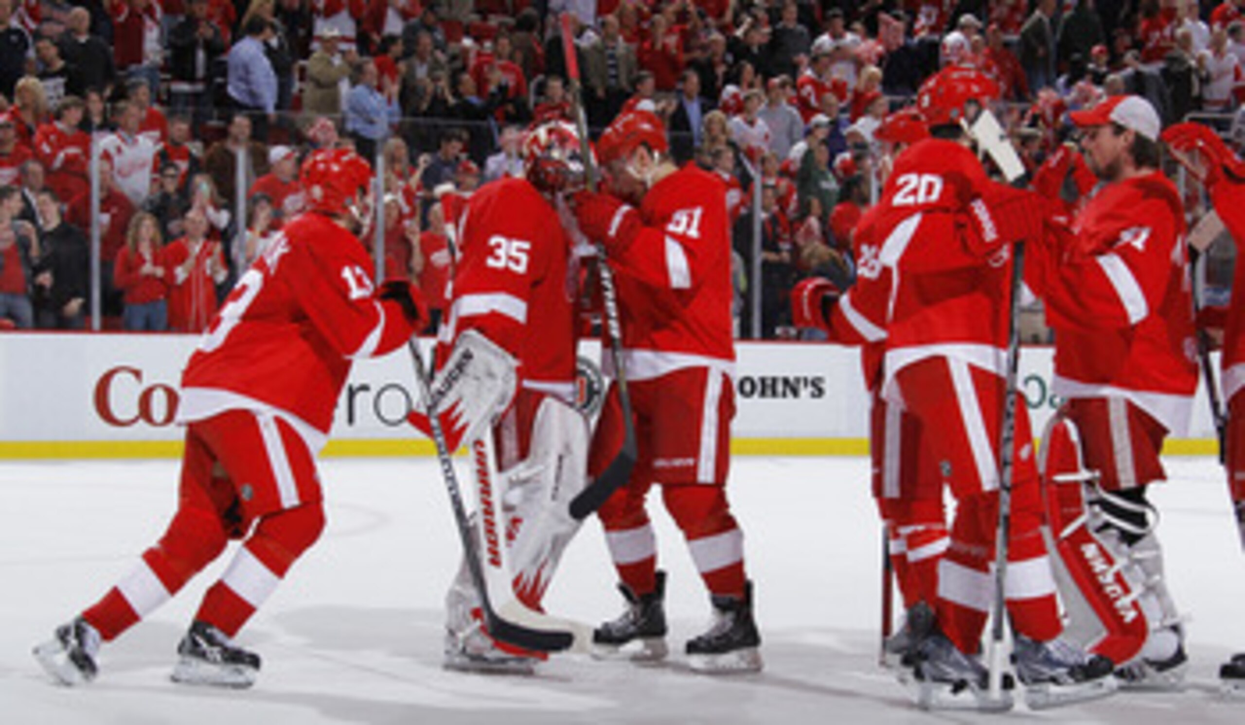 SAN JOSE, CA - MAY 08:  Drew Miller #20 (from left), Jonathan Ericsson #52 and Niklas Kronwall #55  of the Detroit Red Wings celebrate on the bench after Tomas Holmstrom #96 of the Detroit Red Wings scored the winning goal against the San Jose Sharks  in