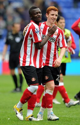BOLTON, ENGLAND - MAY 07:  Sulley Muntari of Sunderland celebrates at full-time with team-mate Jack Colback (R) following the Barclays Premier League match between Bolton Wanderers and Sunderland at Reebok Stadium on May 7, 2011 in Bolton, England.  (Phot