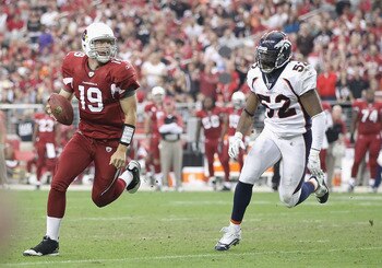 GLENDALE, AZ - DECEMBER 12:  Quarterback John Skelton #19 of the Arizona Cardinals scrambles with the football under pressure from Jason Hunter #52 of the Denver Broncos during the NFL game at the University of Phoenix Stadium on December 12, 2010 in Glen