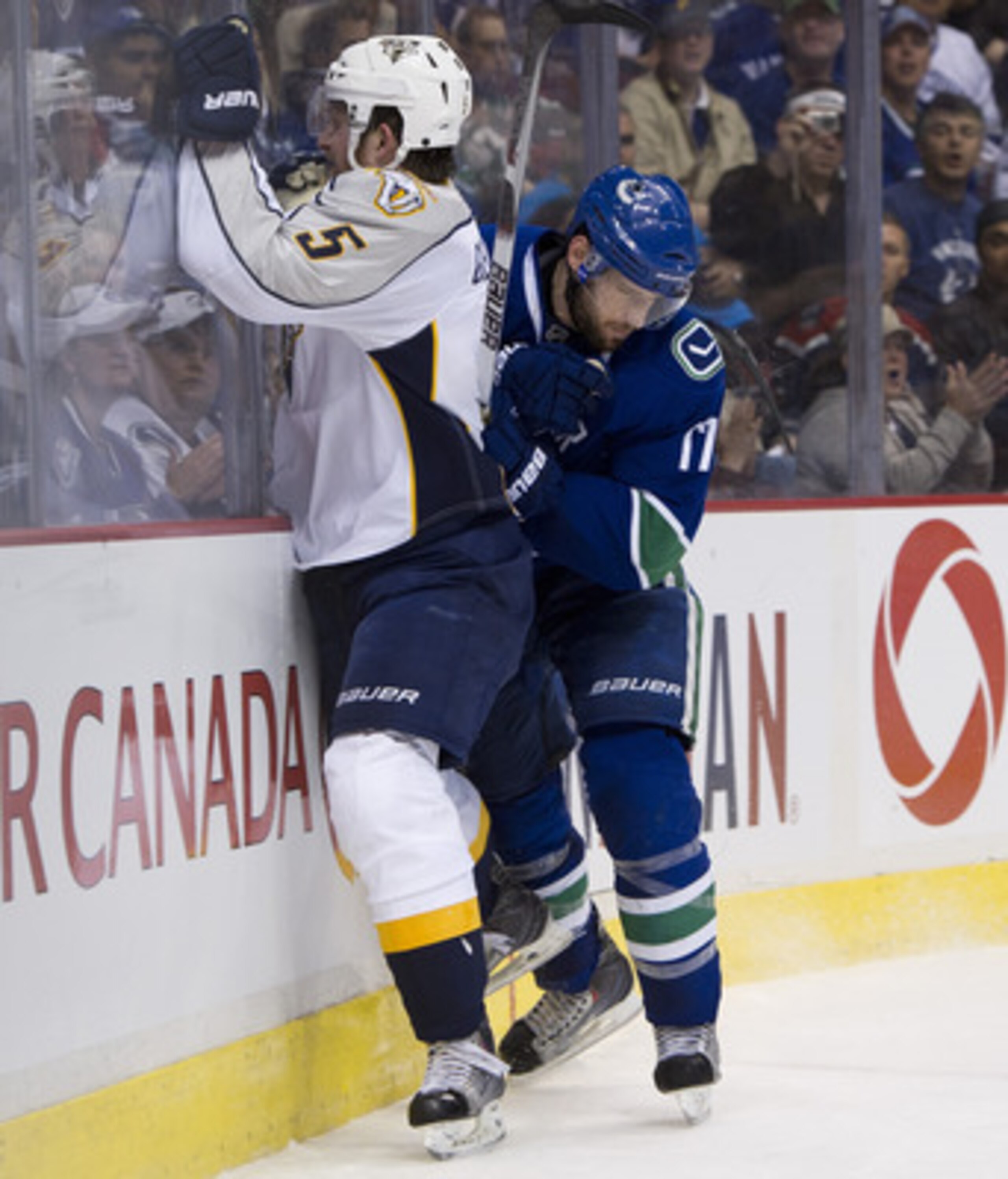 VANCOUVER, CANADA - MAY 7: Ryan Kesler #17 of the Vancouver Canucks checks Blake Geoffrion #5 of the Nashville Predators into the end boards during the third period in Game Five of the Western Conference Semifinals during the 2011 NHL Stanley Cup Playoffs