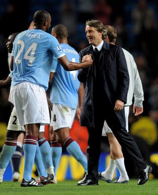 MANCHESTER, ENGLAND - MAY 10:  Manchester City Manager Roberto Mancini congratulates Patrick Vieira  at the end of the Barclays Premier League match between Manchester City and Tottenham Hotspur at the City of Manchester Stadium on May 10, 2011 in Manches