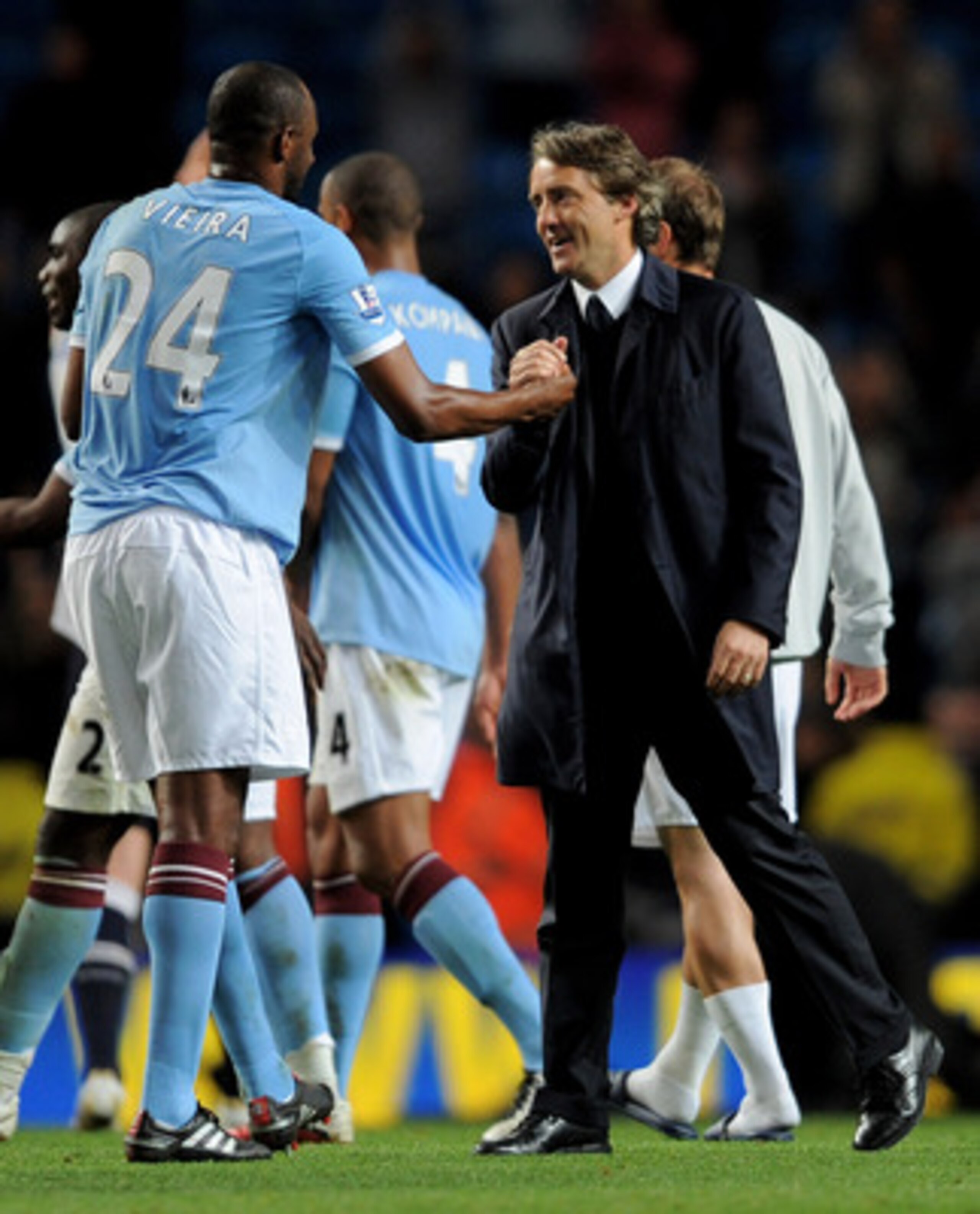 MANCHESTER, ENGLAND - MAY 10:  Manchester City Manager Roberto Mancini congratulates Patrick Vieira  at the end of the Barclays Premier League match between Manchester City and Tottenham Hotspur at the City of Manchester Stadium on May 10, 2011 in Manches