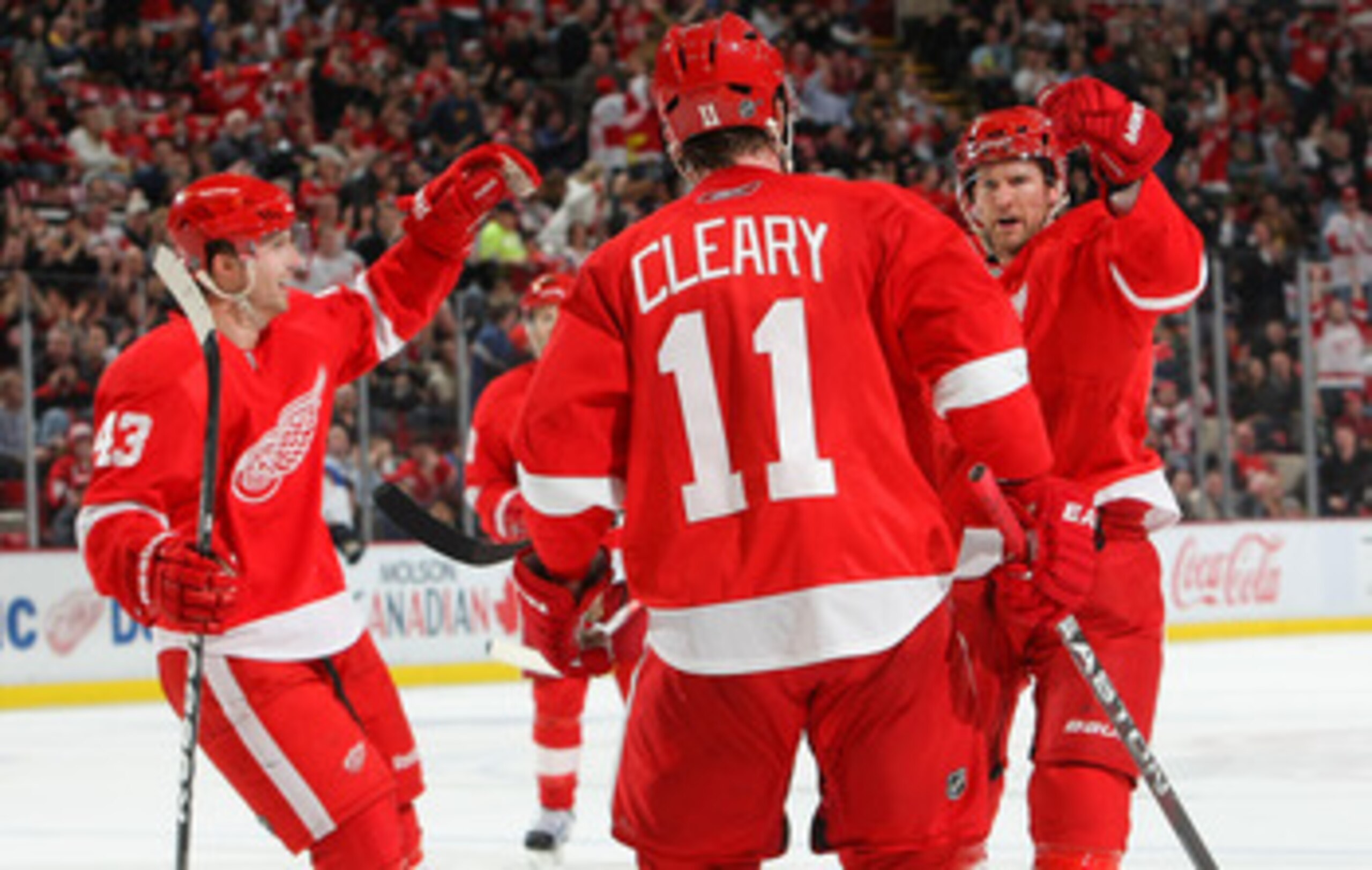 DETROIT,MI - DECEMBER 15:  Niklas Kronwall #55 of the Detroit Red Wings celebrates his 2nd period goal agianst the St.Louis Blues with temamates Darren Helm #43 and Dan Cleary #11 both of the Detroit Red Wings during their NHL game at Joe Louis Arena on D