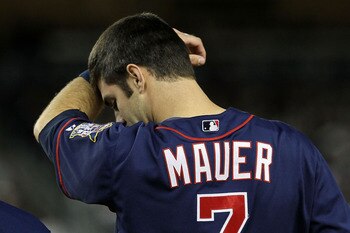 NEW YORK - OCTOBER 09:  Joe Mauer #7 of the Minnesota Twins wipes his forehead against the New York Yankees during Game Three of the ALDS part of the 2010 MLB Playoffs at Yankee Stadium on October 9, 2010 in the Bronx borough of New York City.  (Photo by