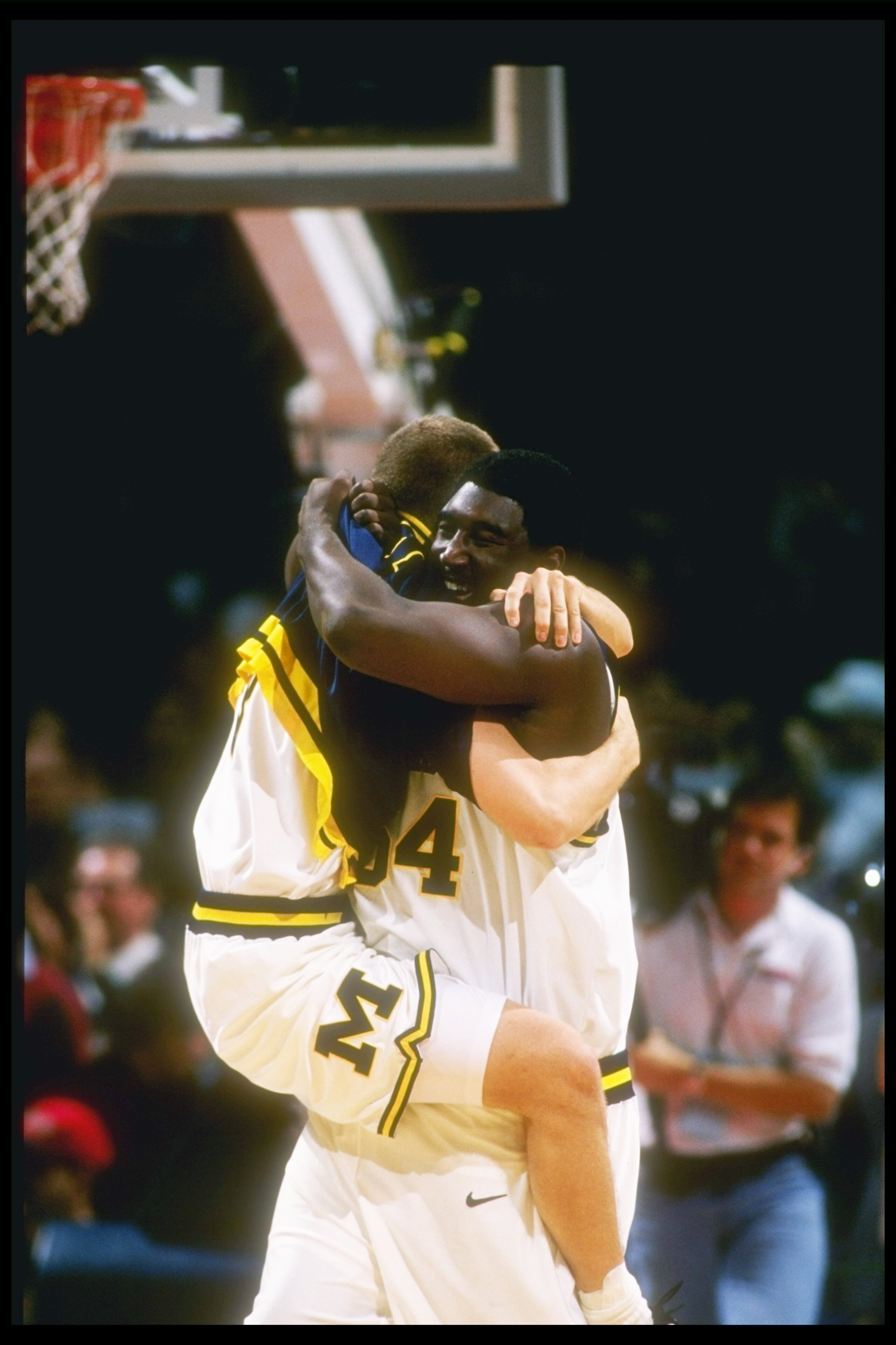 21 Dec 1996:  Center Robert Traylor (standing) of the Michigan Wolverines celebrates his victory with teammate Ryan DeKuiper during a game against the Arizona Wildcats at The Palace of Auburn Hills in Auburn Hills, Michigan. Michigan won 73-71. Mandatory