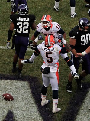 CHICAGO - NOVEMBER 20: Darius Millines #15 of the Illinois Fighting Illini jumps on teammate Mikel Leshoure #5 after Leshoure scored his first touchdown against the Northwestern Wildcats during a game played at Wrigley Field on November 20, 2010 in Chicag
