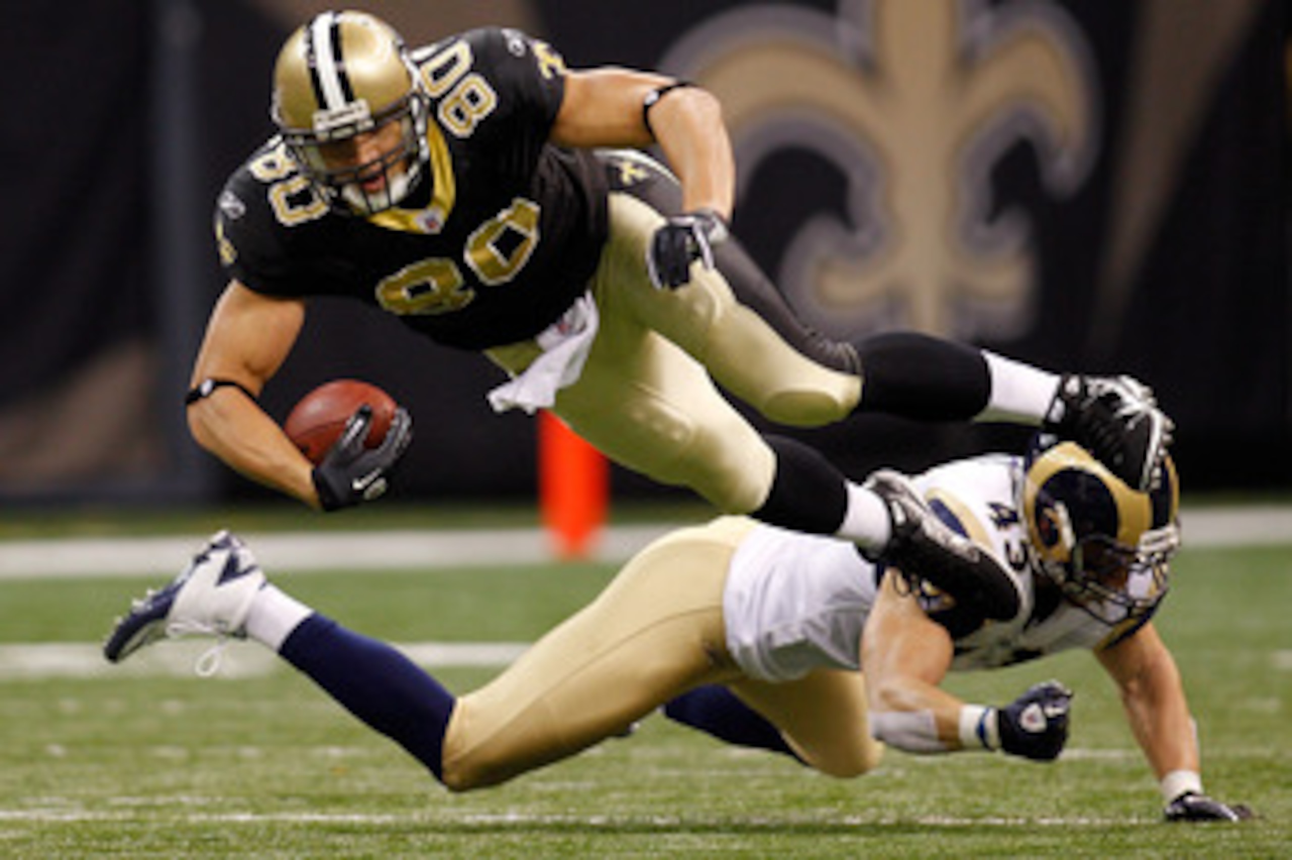 NEW ORLEANS, LA - DECEMBER 12:  Jimmy Graham #80 of the New Orleans Saints is tackled by Craig Dahl #43 of the St. Louis Rams at the Louisiana Superdome on December 12, 2010 in New Orleans, Louisiana.  (Photo by Chris Graythen/Getty Images)
