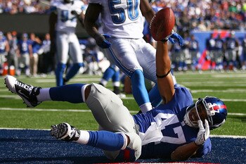 EAST RUTHERFORD, NJ - OCTOBER 17: Travis Beckum #47 of the New York Giants celebrates after scoring a touch down in the third quarter against the Detroit Lions at New Meadowlands Stadium on October 17, 2010 in East Rutherford, New Jersey.  The Giants defe