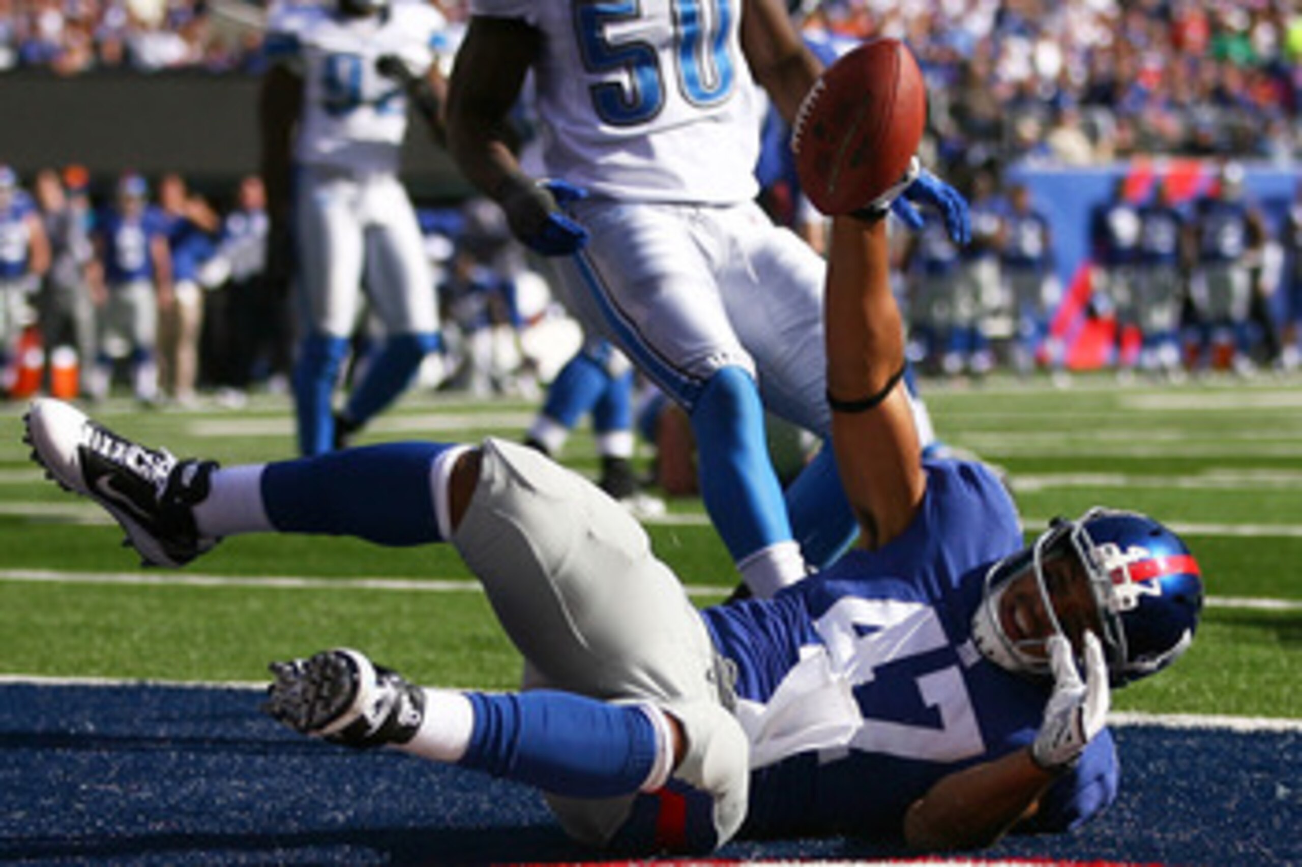 EAST RUTHERFORD, NJ - OCTOBER 17: Travis Beckum #47 of the New York Giants celebrates after scoring a touch down in the third quarter against the Detroit Lions at New Meadowlands Stadium on October 17, 2010 in East Rutherford, New Jersey.  The Giants defe