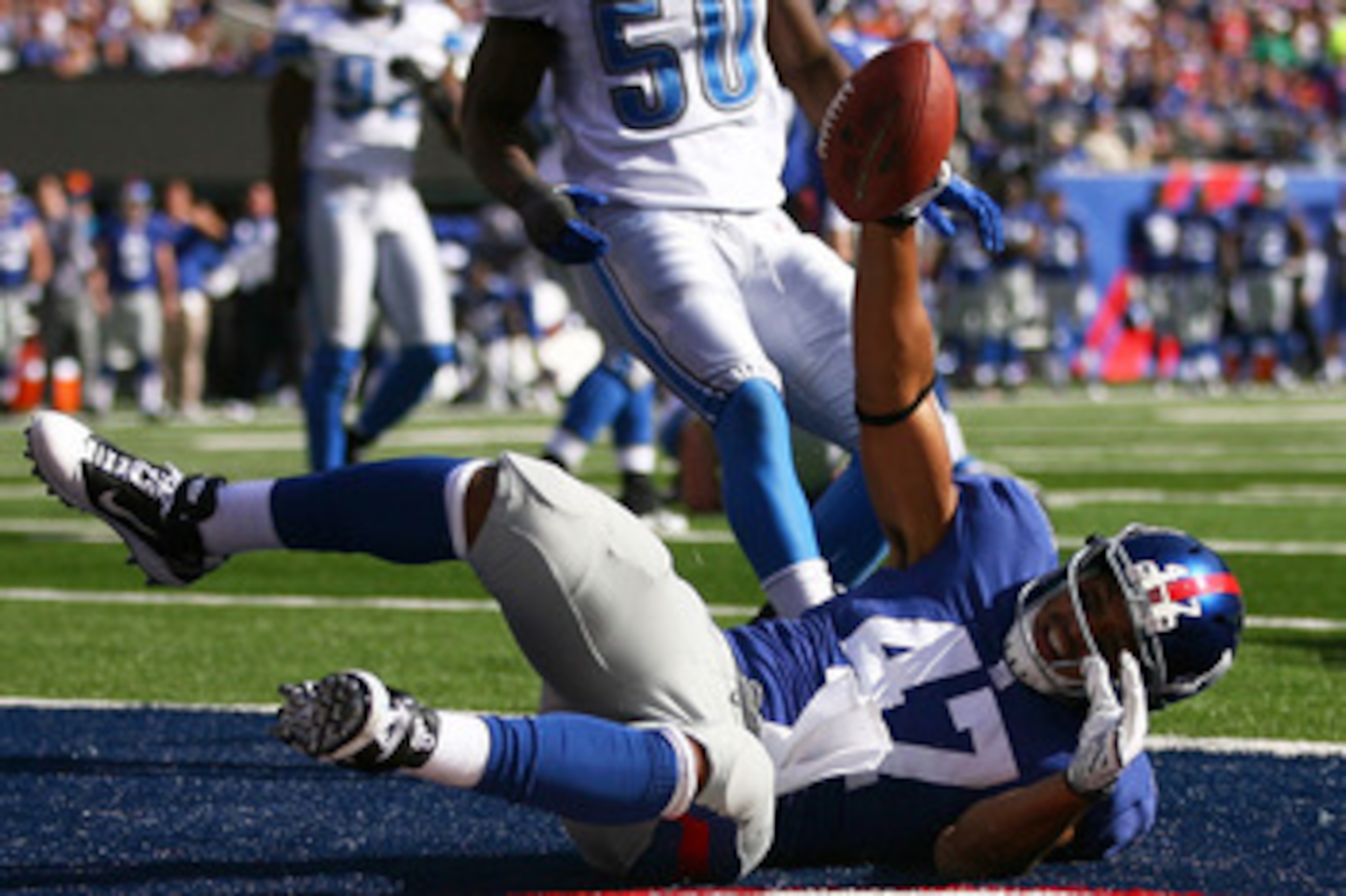 EAST RUTHERFORD, NJ - OCTOBER 17: Travis Beckum #47 of the New York Giants celebrates after scoring a touch down in the third quarter against the Detroit Lions at New Meadowlands Stadium on October 17, 2010 in East Rutherford, New Jersey.  The Giants defe