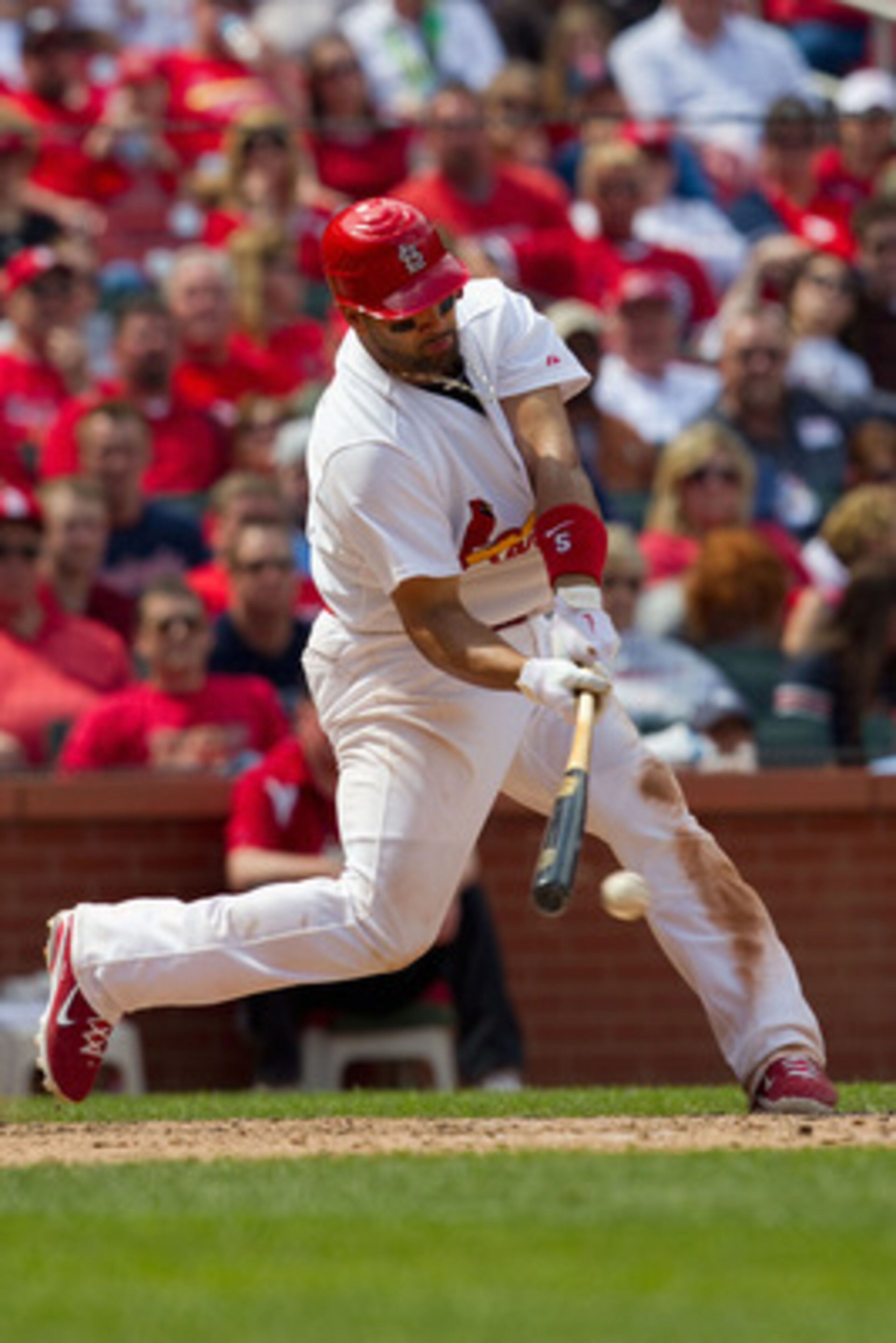 ST. LOUIS, MO - MAY 5: Albert Pujols #5 of the St. Louis Cardinals hits a single against the Florida Marlins at Busch Stadium on May 5, 2011 in St. Louis, Missouri.  (Photo by Dilip Vishwanat/Getty Images)