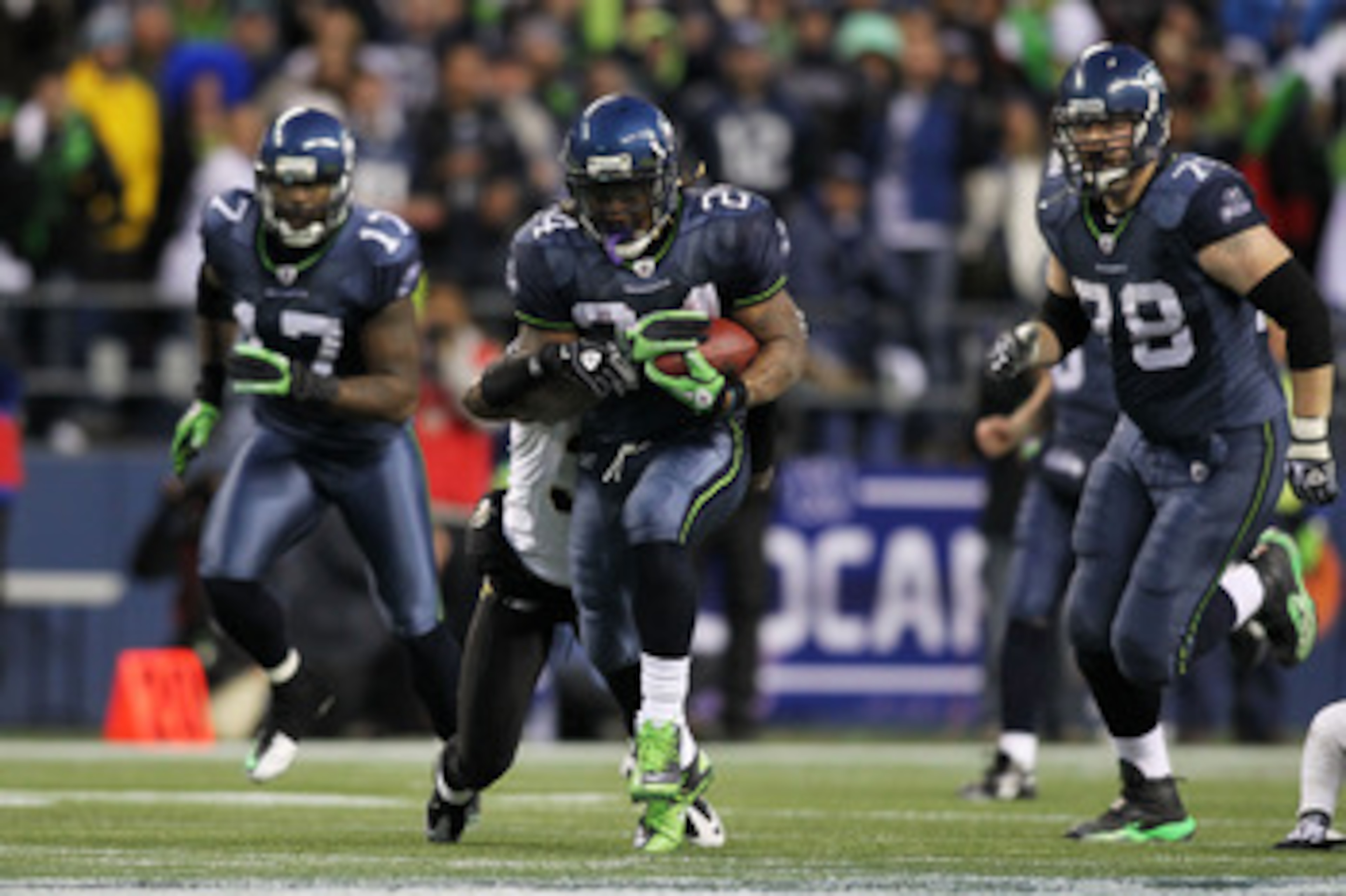 SEATTLE, WA - JANUARY 08:  Running back Marshawn Lynch #24 of the Seattle Seahawks runs for a 67-yard touchdown in the fourth quarter against the New Orleans Saints during the 2011 NFC wild-card playoff game at Qwest Field on January 8, 2011 in Seattle, W
