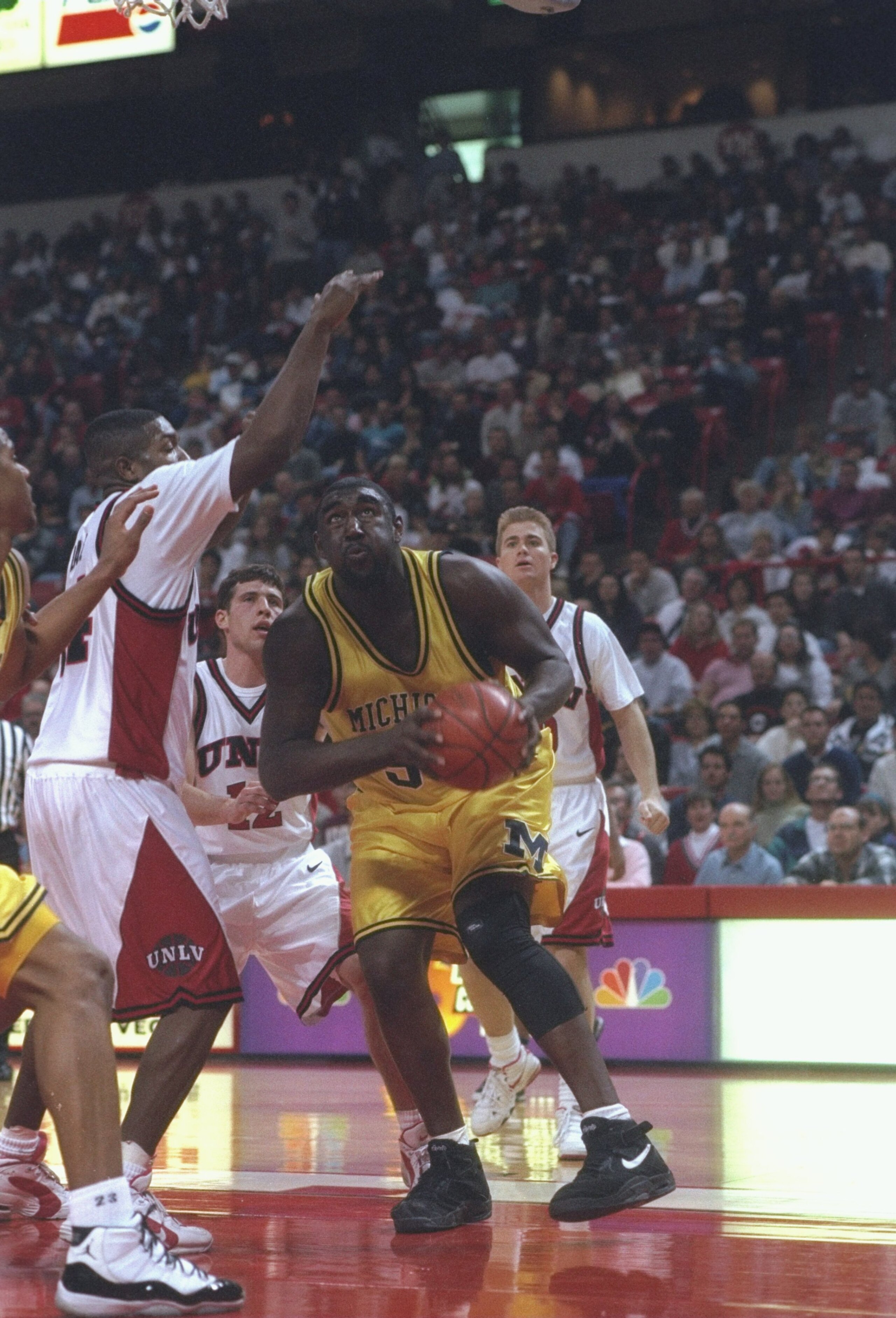 28 Dec 1995:  Center Maurice Traylor of the Michigan Wolverines moves the ball during a game against the UNLV Runnin'' Rebels.  UNLV won the game, 66-64. Mandatory Credit: Stephen Dunn  /Allsport