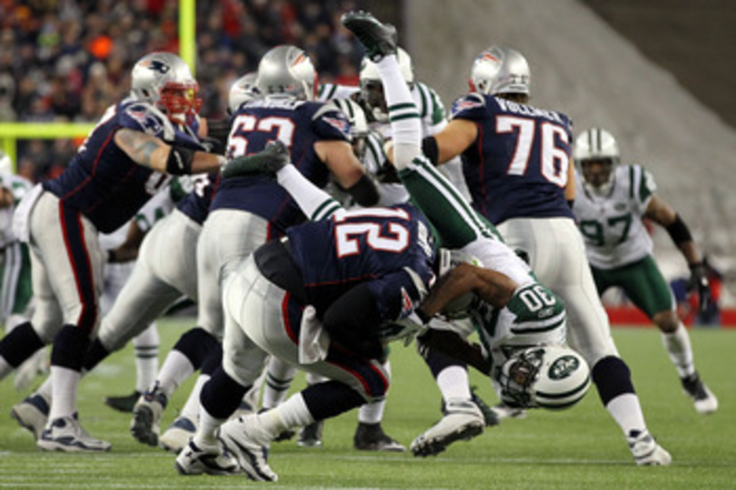 FOXBORO, MA - JANUARY 16:  Tom Brady #12 of the New England Patriots is sacked by Drew Coleman #30 of the New York Jets during their 2011 AFC divisional playoff game at Gillette Stadium on January 16, 2011 in Foxboro, Massachusetts.  (Photo by Al Bello/Ge
