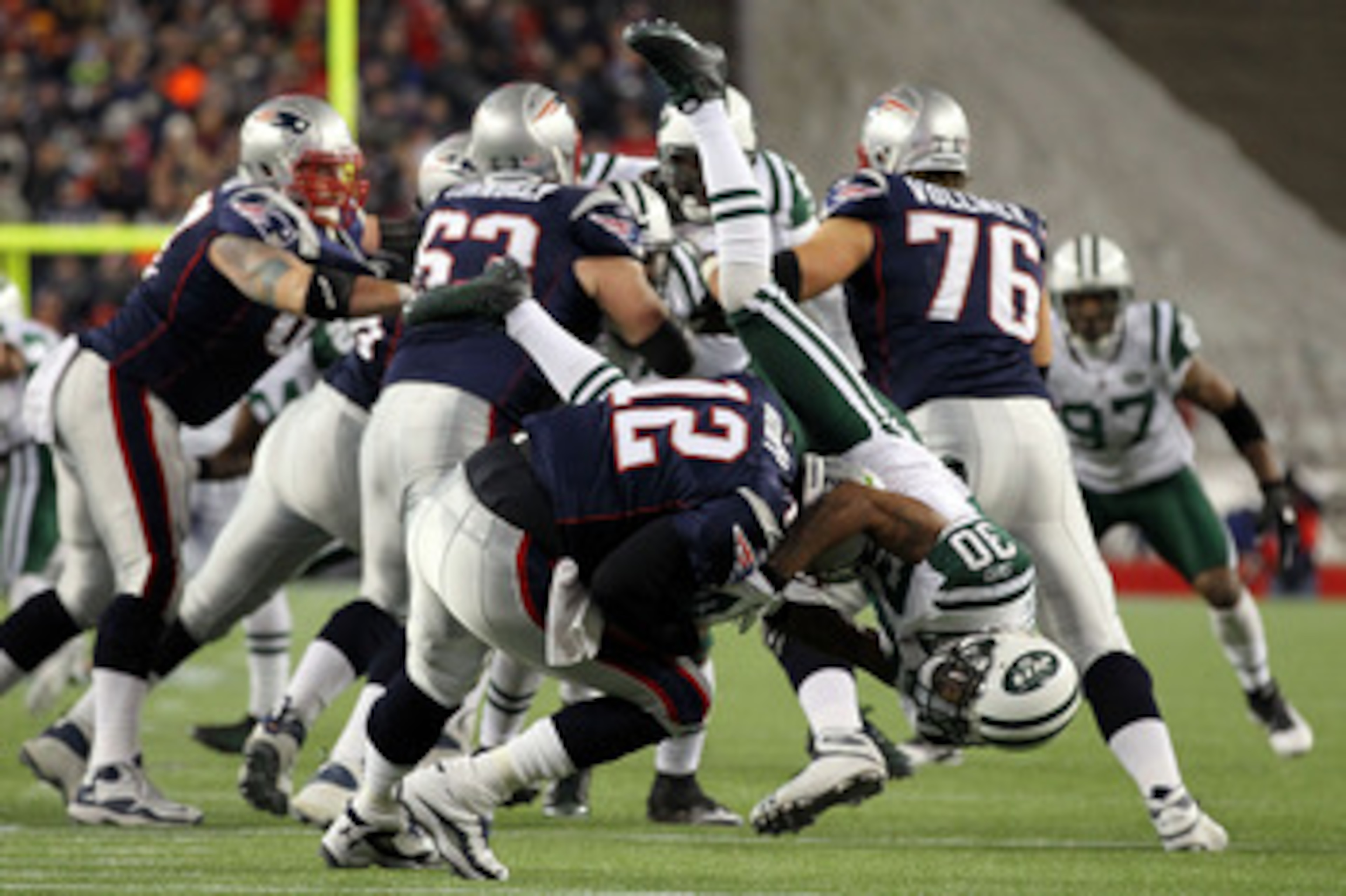 FOXBORO, MA - JANUARY 16:  Tom Brady #12 of the New England Patriots is sacked by Drew Coleman #30 of the New York Jets during their 2011 AFC divisional playoff game at Gillette Stadium on January 16, 2011 in Foxboro, Massachusetts.  (Photo by Al Bello/Ge