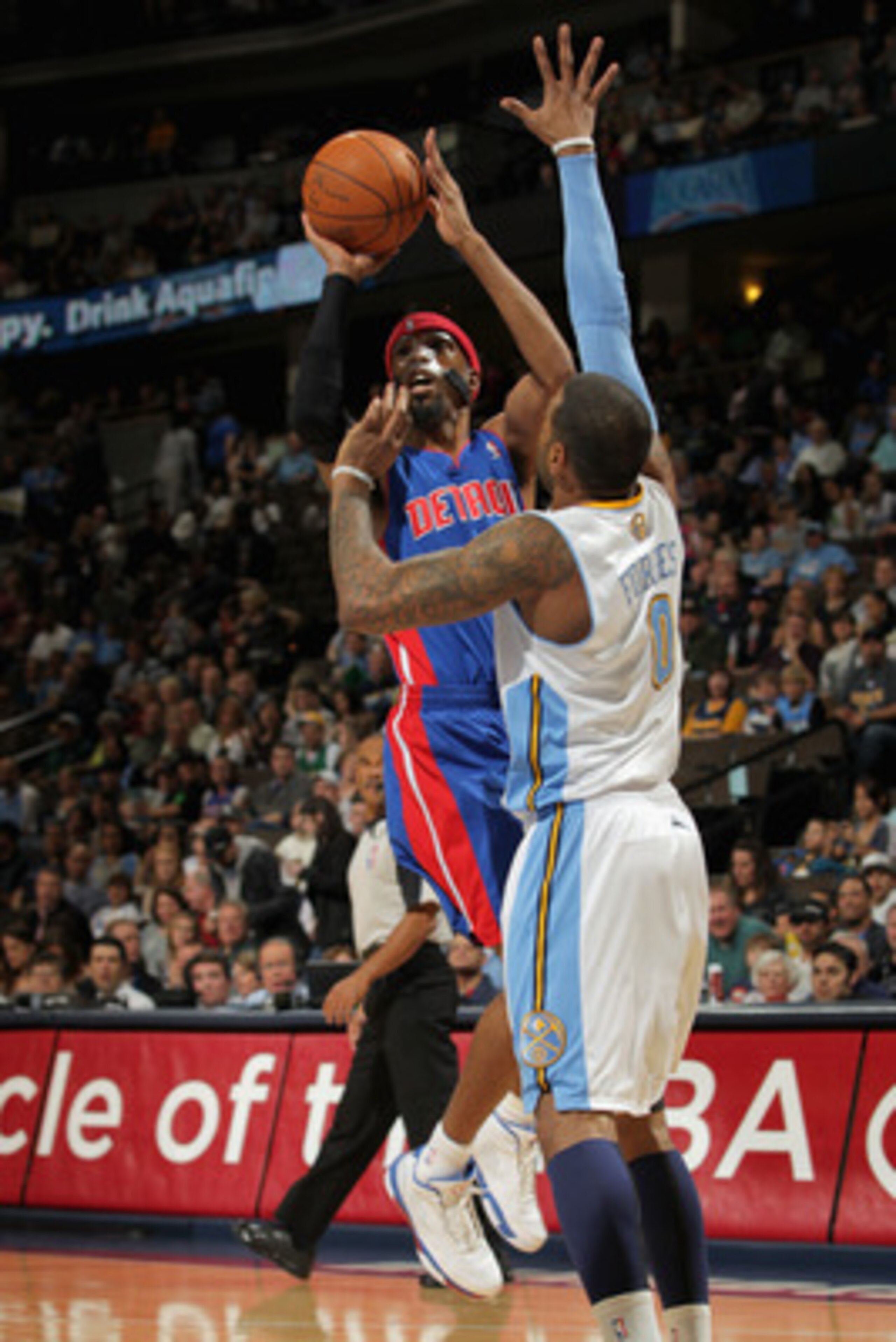DENVER, CO - MARCH 12:  Richard Hamilton #32 of the Detroit Pistons takes a shot over Gary Forbes #0 of the Denver Nuggets at the Pepsi Center on March 12, 2011 in Denver, Colorado. NOTE TO USER: User expressly acknowledges and agrees that, by downloading