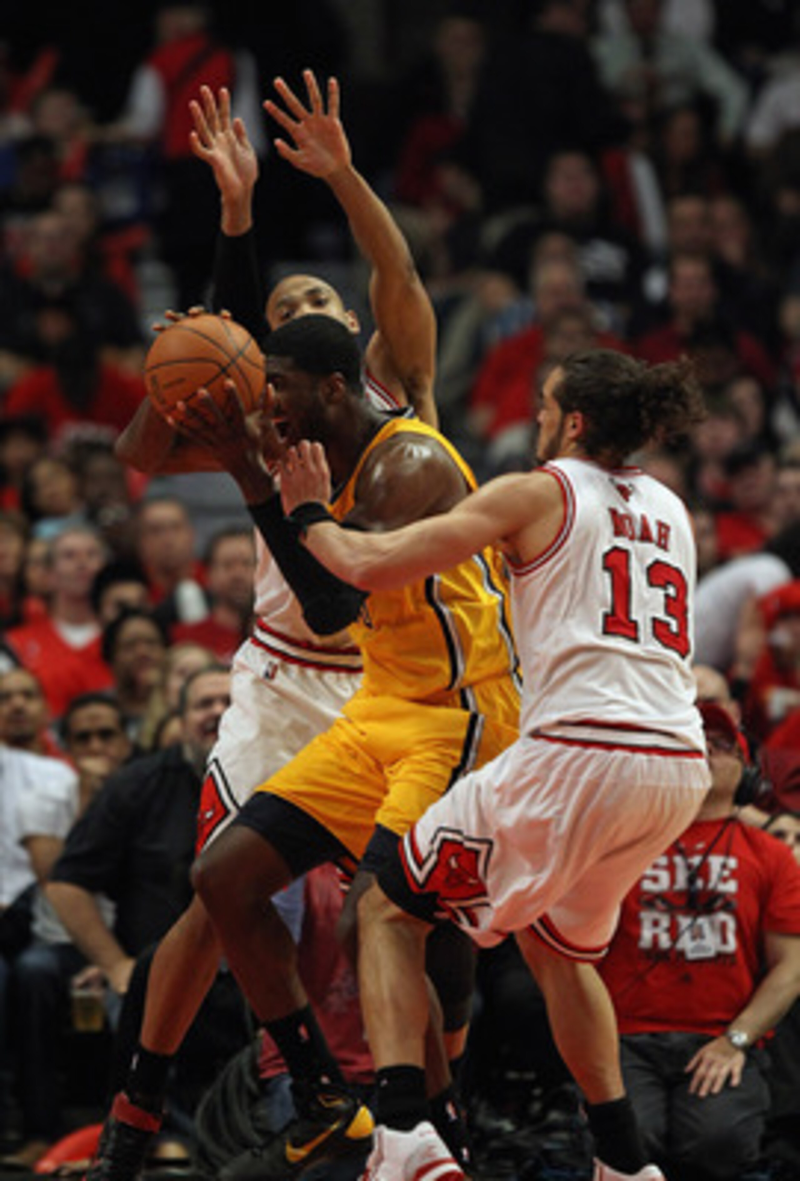 CHICAGO, IL - APRIL 26: Joakim Noah #13 and Taj Gibson #22 of the Chicago Bulls defend against Roy Hibbert #55 of the Indiana Pacers in Game Five of the Eastern Conference Quarterfinals in the 2011 NBA Playoffs at the United Center on April 26, 2011 in Ch