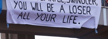 ISTANBUL, TURKEY - AUGUST 26:  Fans of Fernando Alonso of Spain and McLaren Mercedes hold a sign saying 'Ham Tearful, swindler you will be a loser all your life' aimed at Lewis Hamilton of Great Britain and McLaren Mercedes during the F1 Grand Prix of Tur