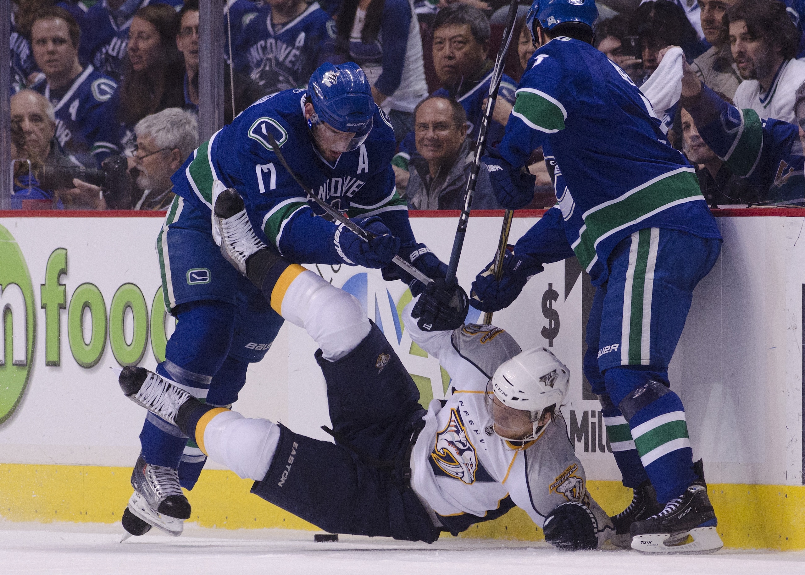 VANCOUVER, CANADA - APRIL 28: Ryan Kesler #17 of the Vancouver Canucks knocks Martin Erat #10 of the Nashville Predators to the ice as Kevin Bieksa #3 of the Vancouver Canucks looks on during the first period in Game One of the Western Conference Semifina VANCOUVER, CANADA - APRIL 28: Ryan Kesler #17 of the Vancouver Canucks knocks Martin Erat #10 of the Nashville Predators to the ice as Kevin Bieksa #3 of the Vancouver Canucks looks on during the first period in Game One of the Western Conference Semifina