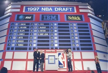 25 Jun 1997: Olivier Saint-Jean of the Sacramento Kings shakes hands with NBA Commissioner David Stern during the NBA Draft at the Charlotte Coliseum in Charlotte, North Carolina.