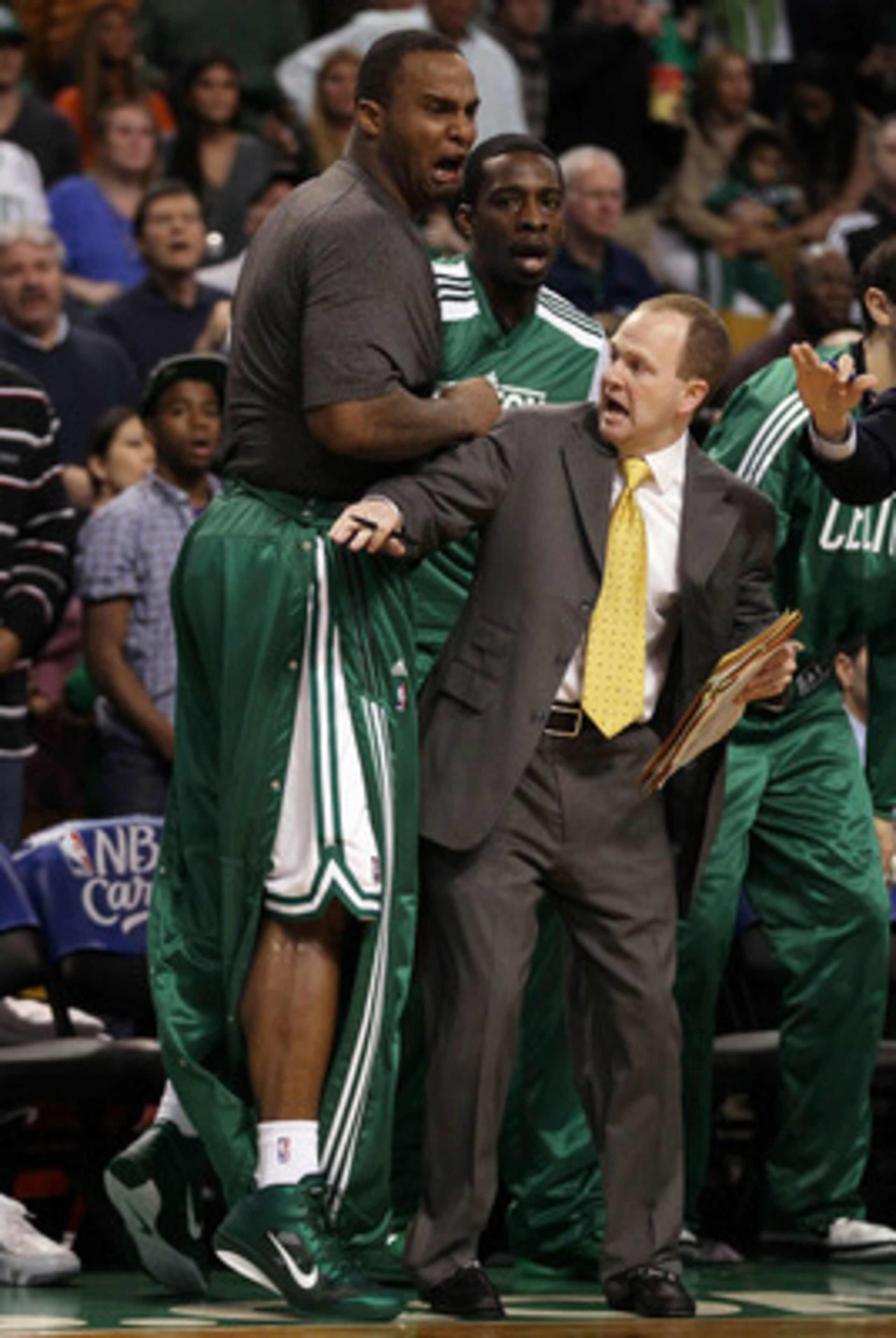 BOSTON, MA - MAY 07:  Assistant coach Lawrence Frank of the Boston Celtics holds back Glen Davis #11 after teammate Rajon Rondo #9 was injured after a scuffle with Dwyane Wade #3 of the Miami Heat in Game Three of the Eastern Conference Semifinals in the 