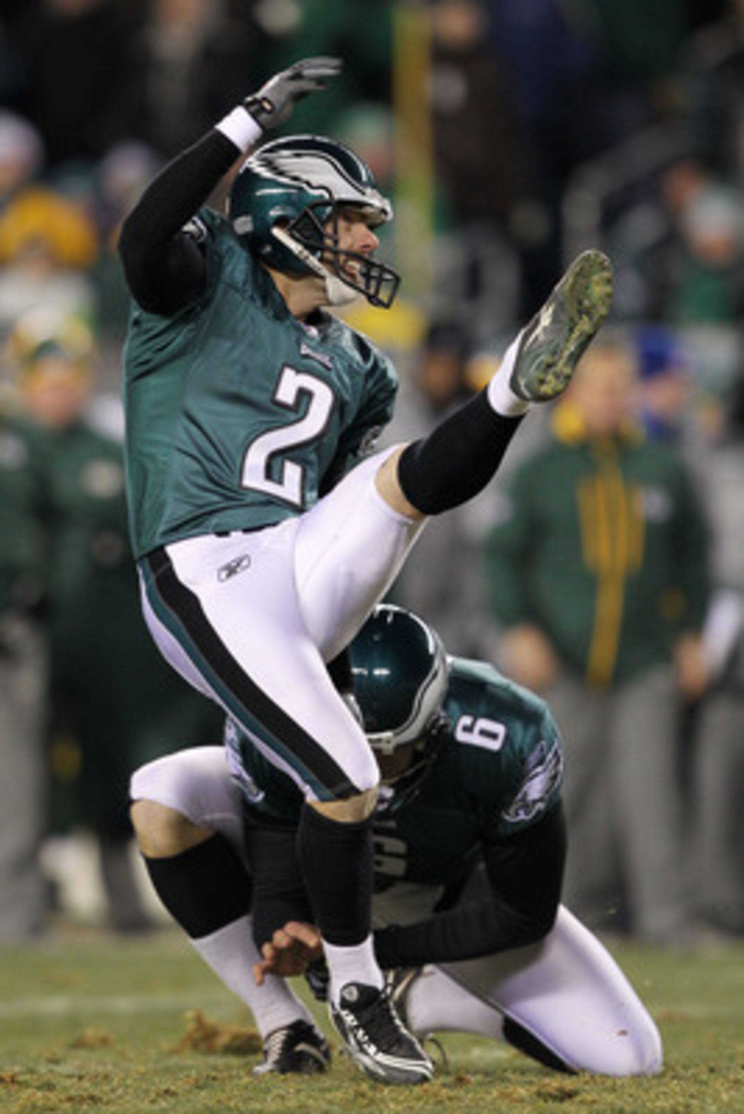 PHILADELPHIA, PA - JANUARY 09:  David Akers #2 kicks as Sav Rocca #6 of the Philadelphia Eagles holds against the Green Bay Packers during the 2011 NFC wild card playoff game at Lincoln Financial Field on January 9, 2011 in Philadelphia, Pennsylvania.  (P