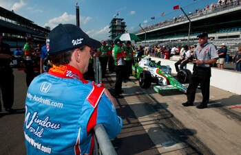 INDIANAPOLIS - MAY 23:  John Andretti driver of the #43 Richard Petty/Andretti Autosport Dallara Honda looks on as the #11 Andretti Autosports Dallara Honda of Tony Kanaan of Brazil is rolled in pit lane for a qualifying attempt during Bump Day qualifying
