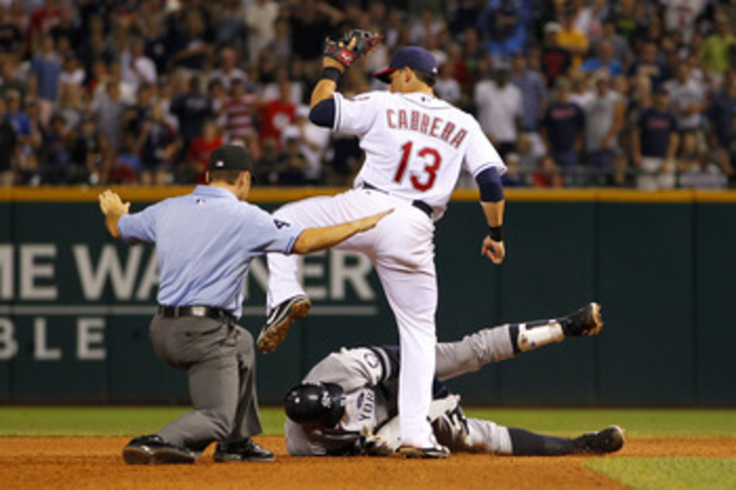 CLEVELAND - JULY 28:  Alex Rodriguez #13 of the New York Yankees is called safe after a sixth inning double next to Asdrubal Cabrera #13 of the Cleveland Indians on July 28, 2010 at Progressive Field in Cleveland, Ohio.  (Photo by Gregory Shamus/Getty Ima