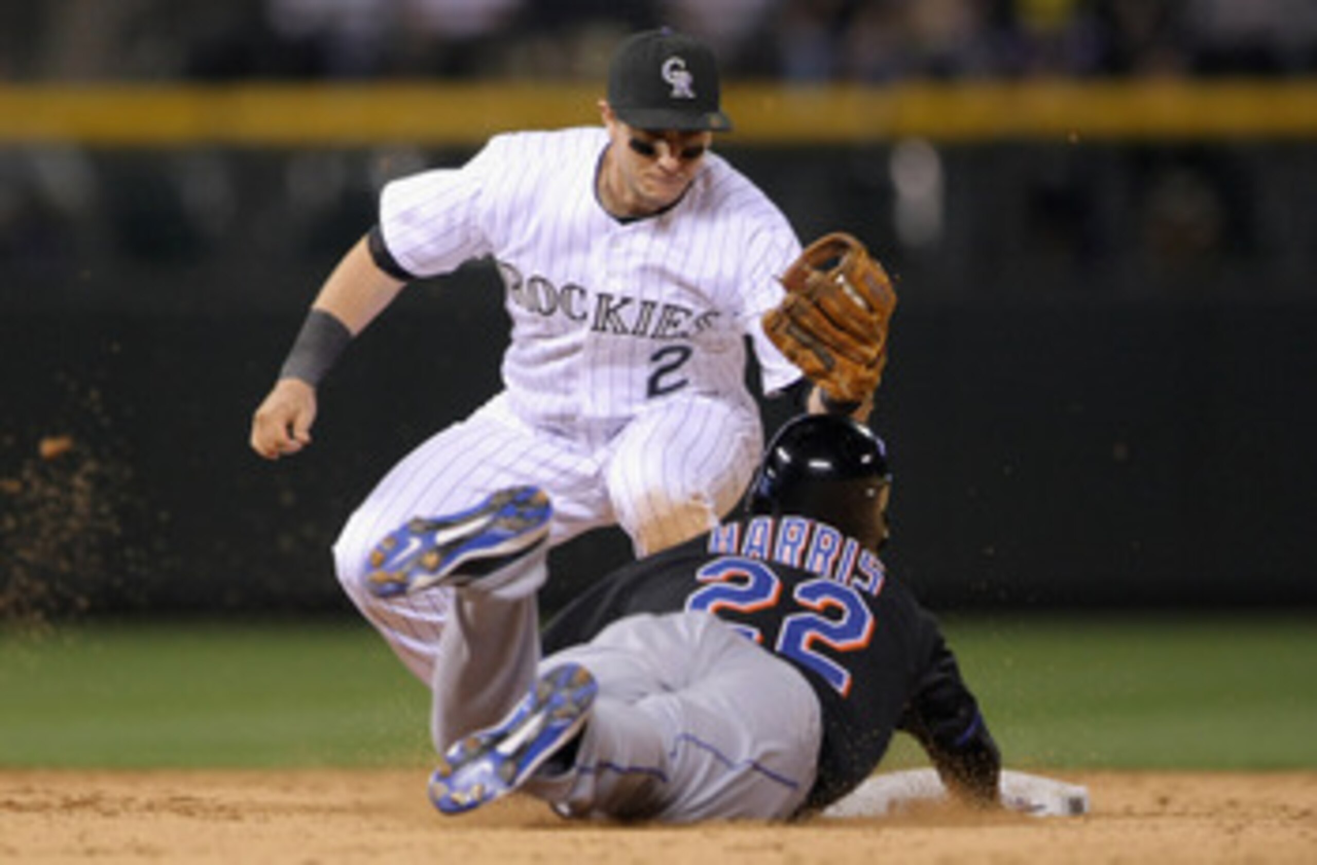 DENVER, CO - MAY 09:  Shortstop Troy Tulowitzki #2 of the Colorado Rockies tags out Willie Harris #22 of the New York Mets as he tries to steal second base in the ninth inning at Coors Field on May 9, 2011 in Denver, Colorado. The Rockies defeated the Met