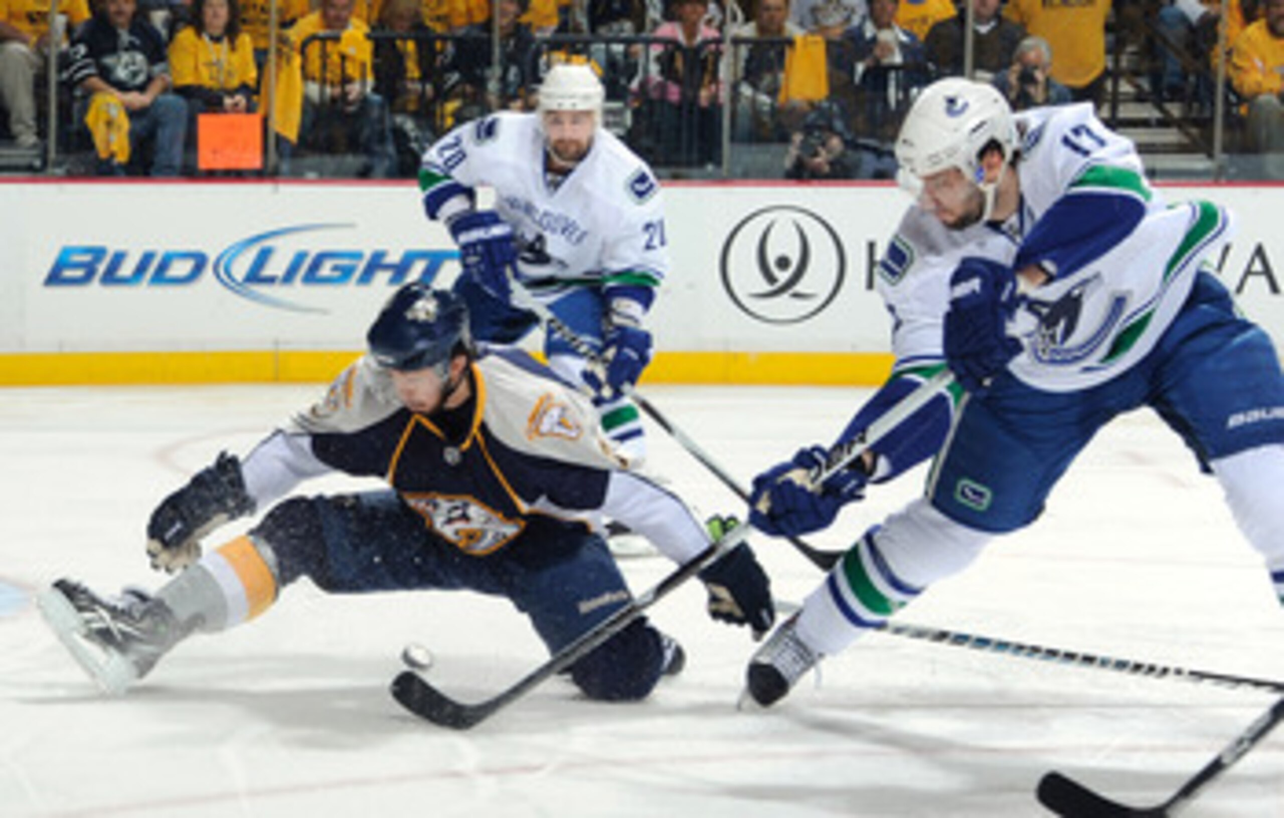 NASHVILLE, TN - MAY 03:  Ryan Kessler #17 of the Vancouver Canucks flips the puck under Jonathon Blum #7 of the Nashville Predators in Game Three of the Western Conference Semifinals during the 2011 NHL Stanley Cup Playoffs at Bridgestone Arena on May 3,