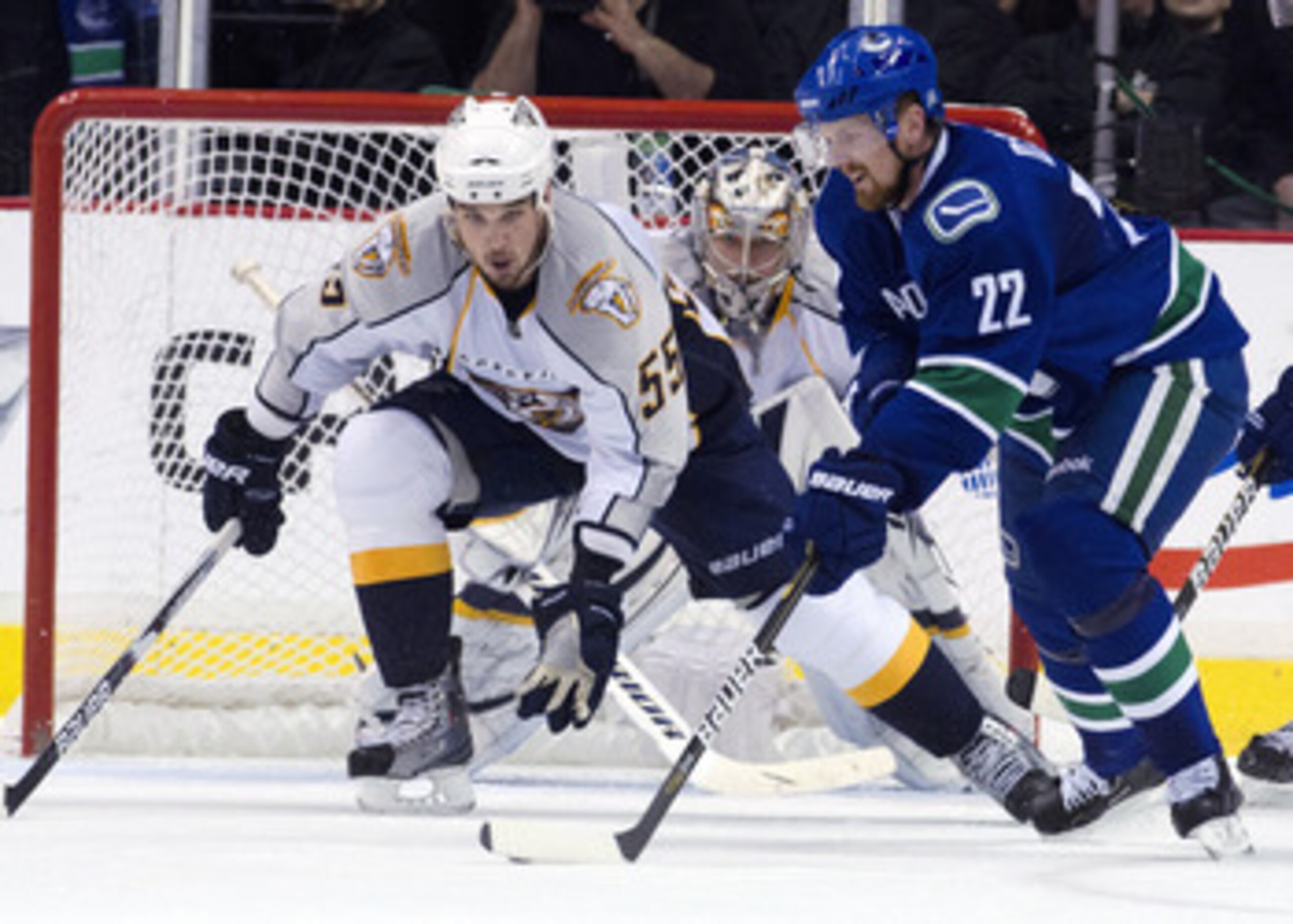 VANCOUVER, CANADA - MAY 7: Daniel Sedin #22 of the Vancouver Canucks being watched by Shane O'Brien #55 and Goalie Pekka Rinne #35 of the Nashville Predators during the second period in Game Five of the Western Conference Semifinals during the 2011 NHL St