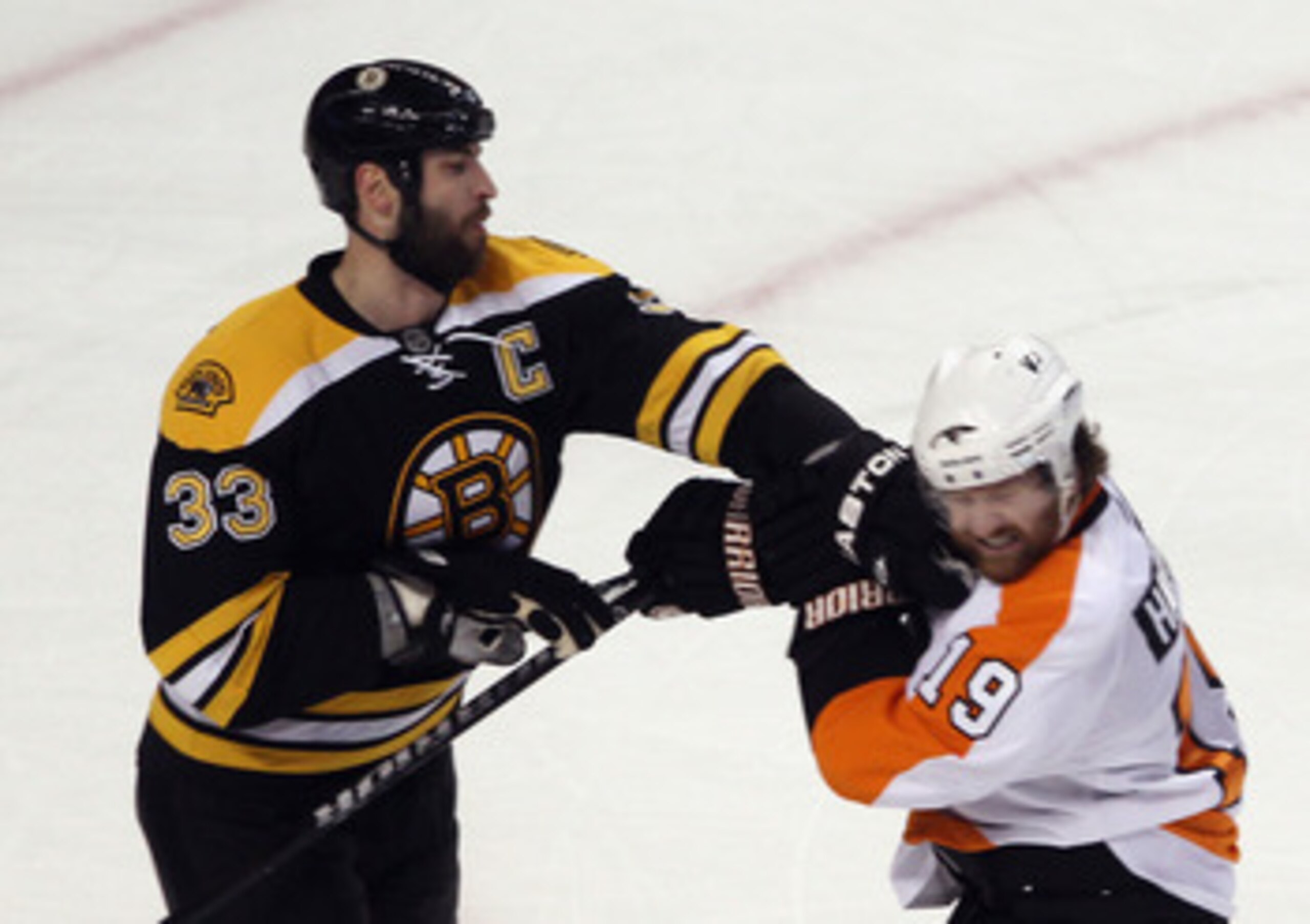 BOSTON, MA - MAY 06:  Zdeno Chara #33 of the Boston Bruins exchanges blows with Scott Hartnell #19 of the Philadelphia Flyers in Game Four of the Eastern Conference Semifinals during the 2011 NHL Stanley Cup Playoffs at TD Garden on May 6, 2011 in Boston,