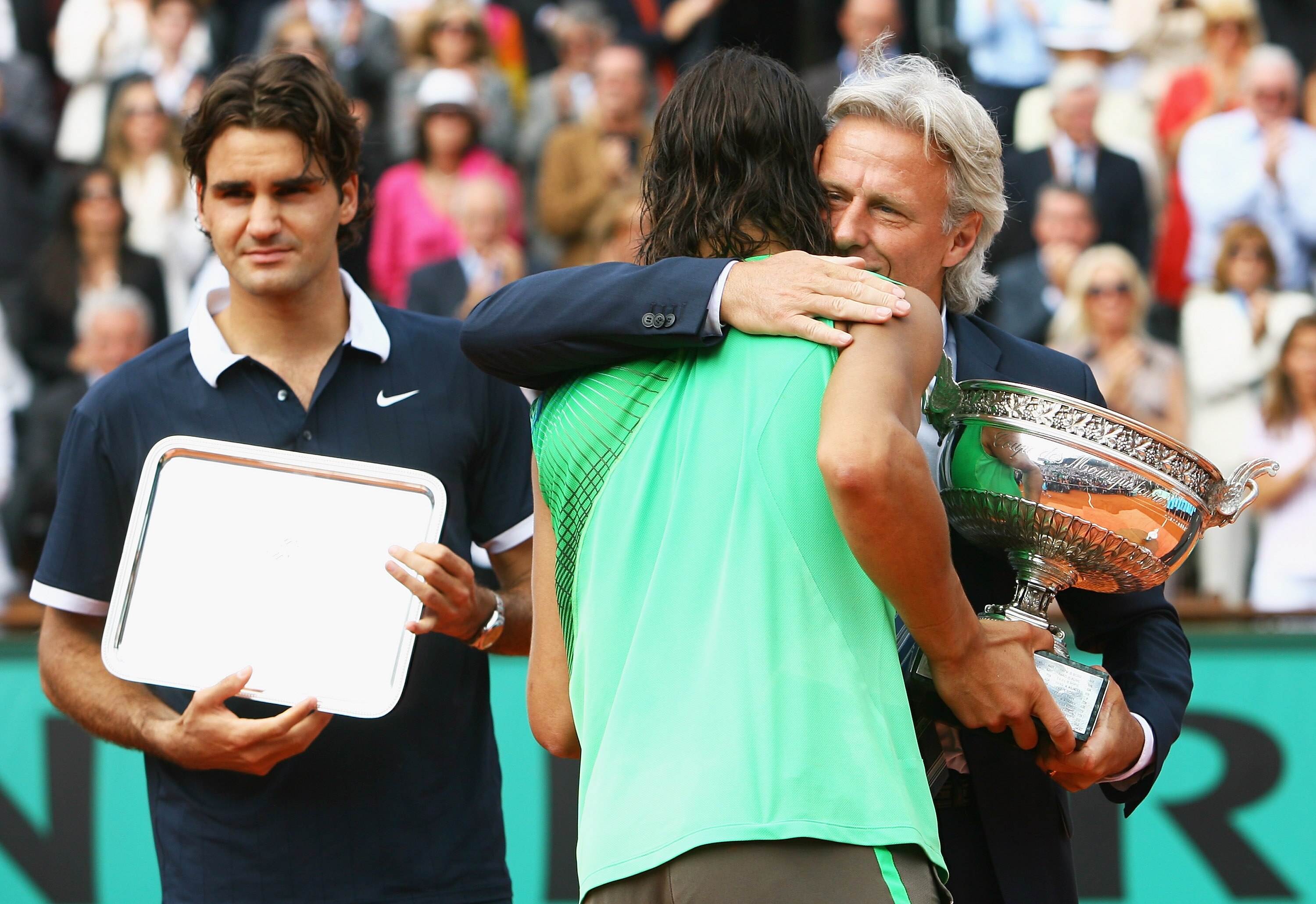 PARIS - JUNE 08:  Rafael Nadal of Spain receives the trophy from Bjorn Borg, as runner up Roger Federer (L) of Switzerland looks on after the Men's Singles Final match on day fifteen of the French Open at Roland Garros on June 8, 2008 in Paris, France.  (